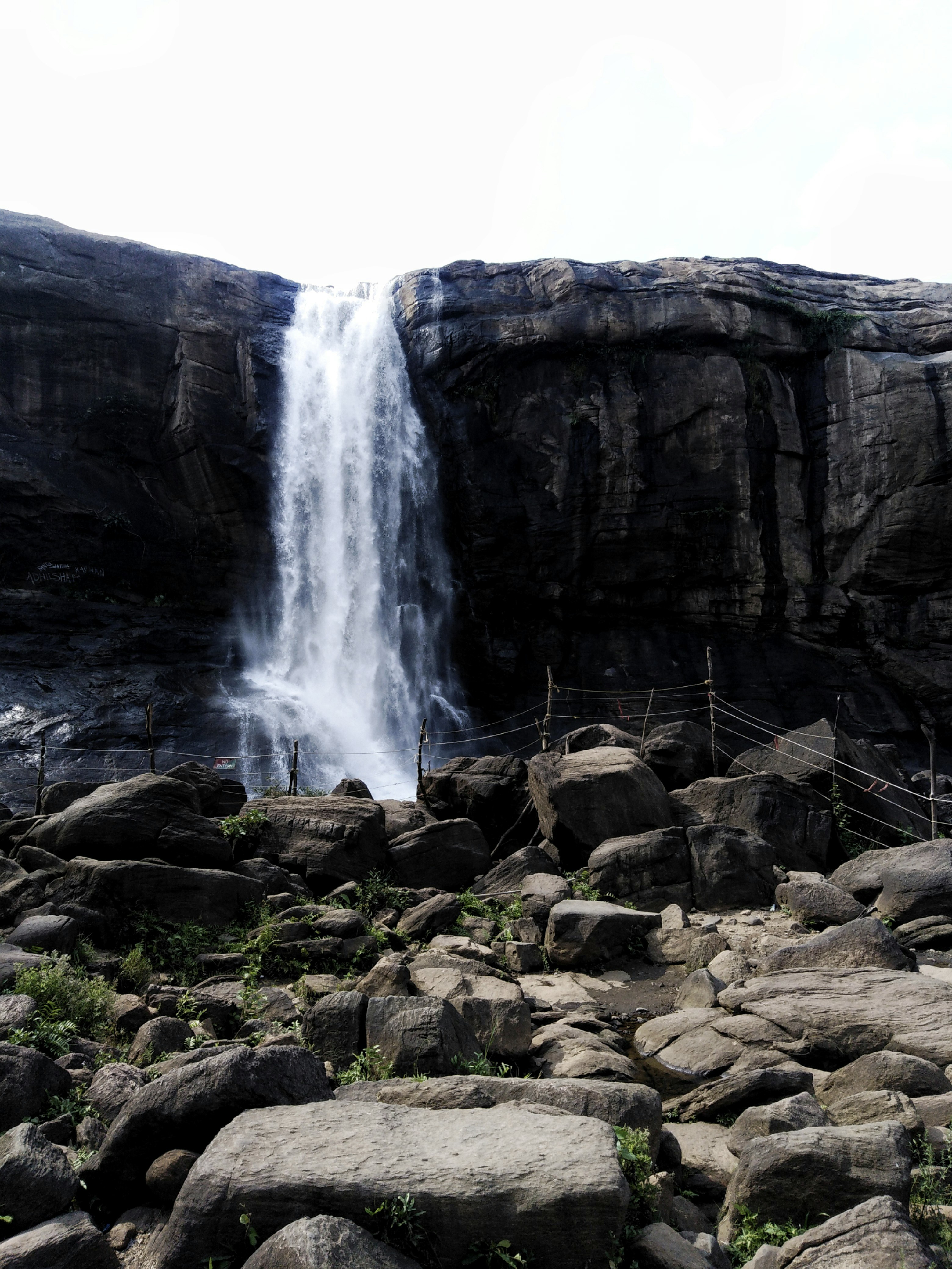 A powerful waterfall cascades down a rocky cliff face.