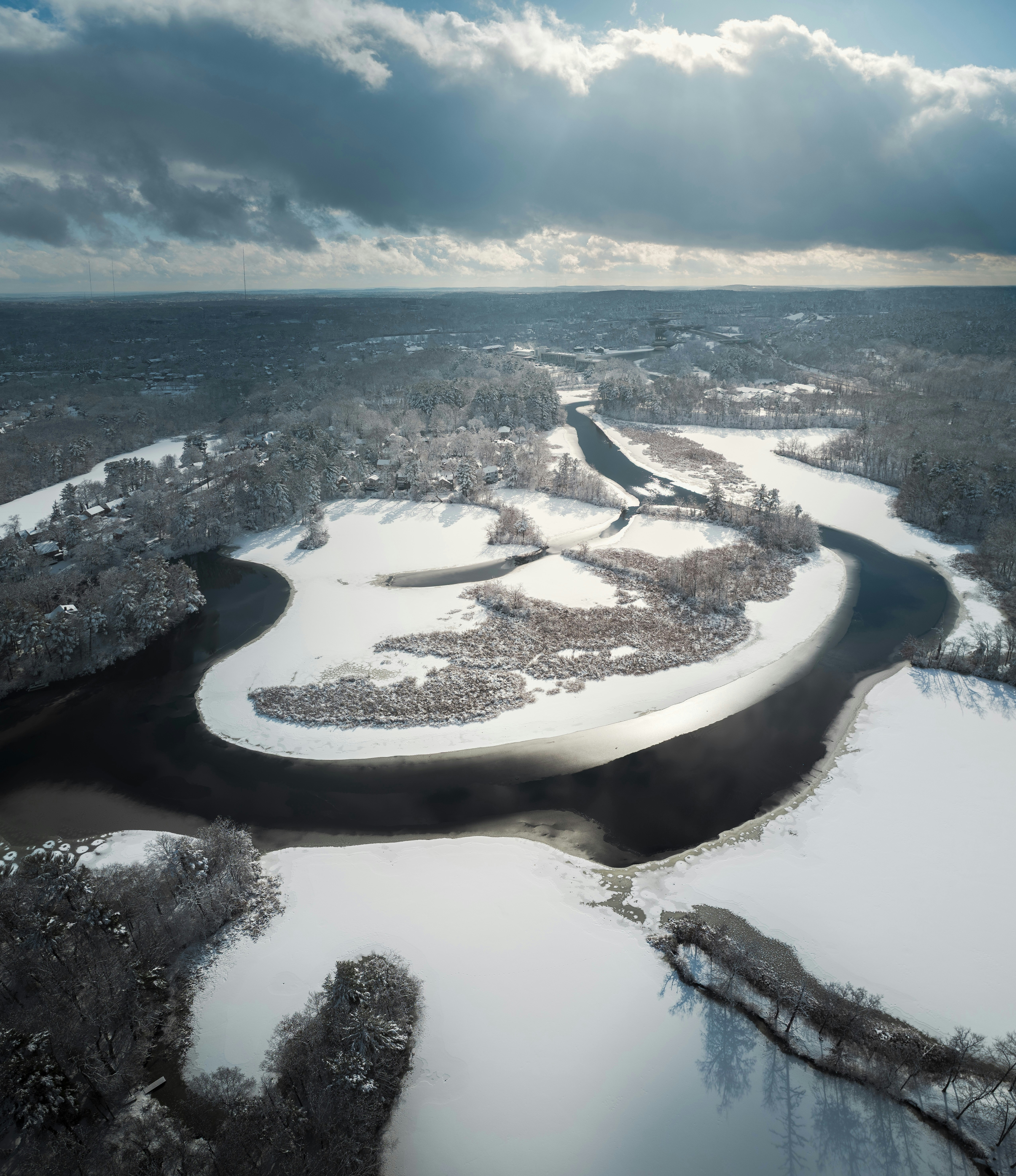 Winding river through a snow-covered forest landscape