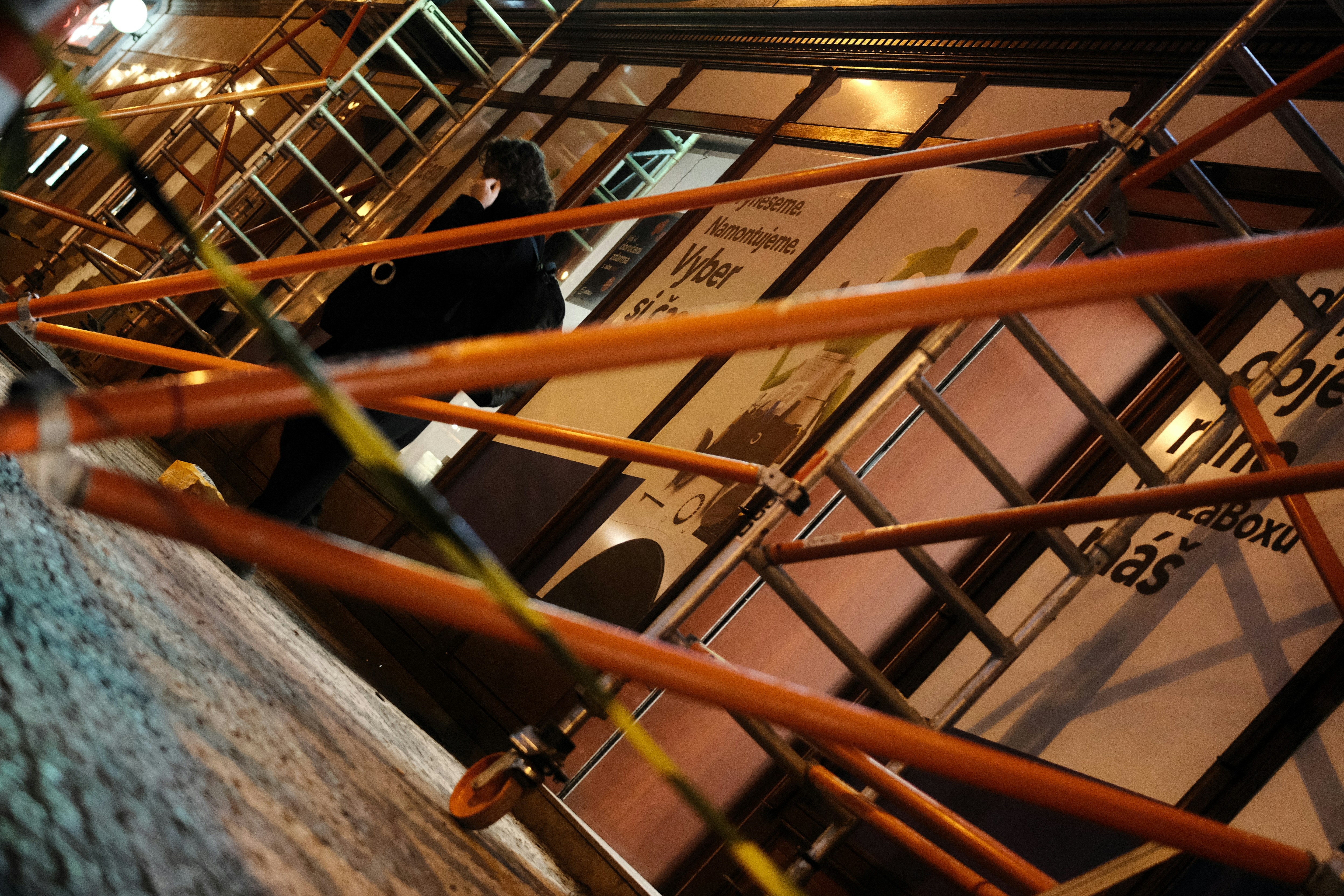 Scaffolding and ladder against a building at night.