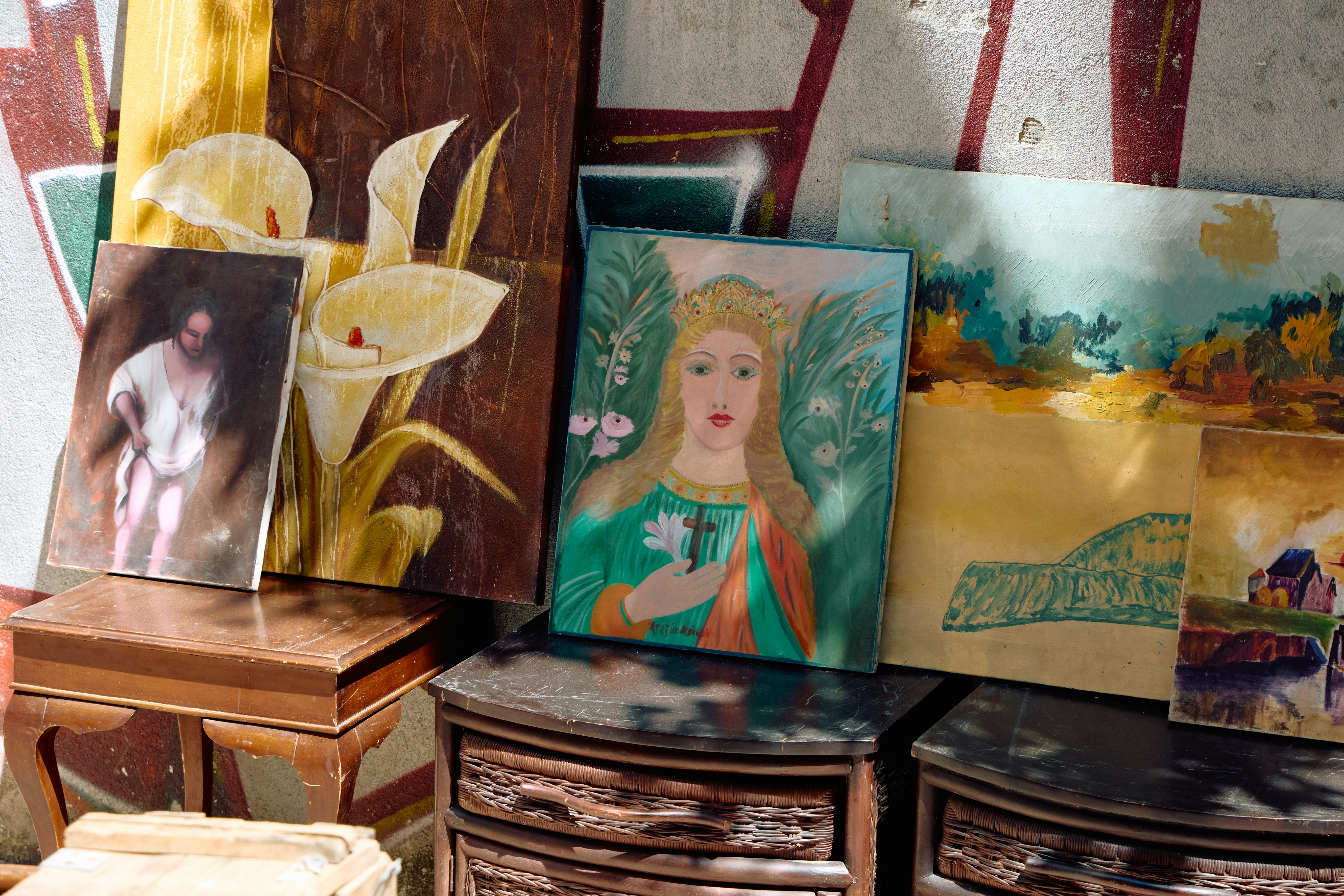 Assortment of paintings and artwork displayed indoors.