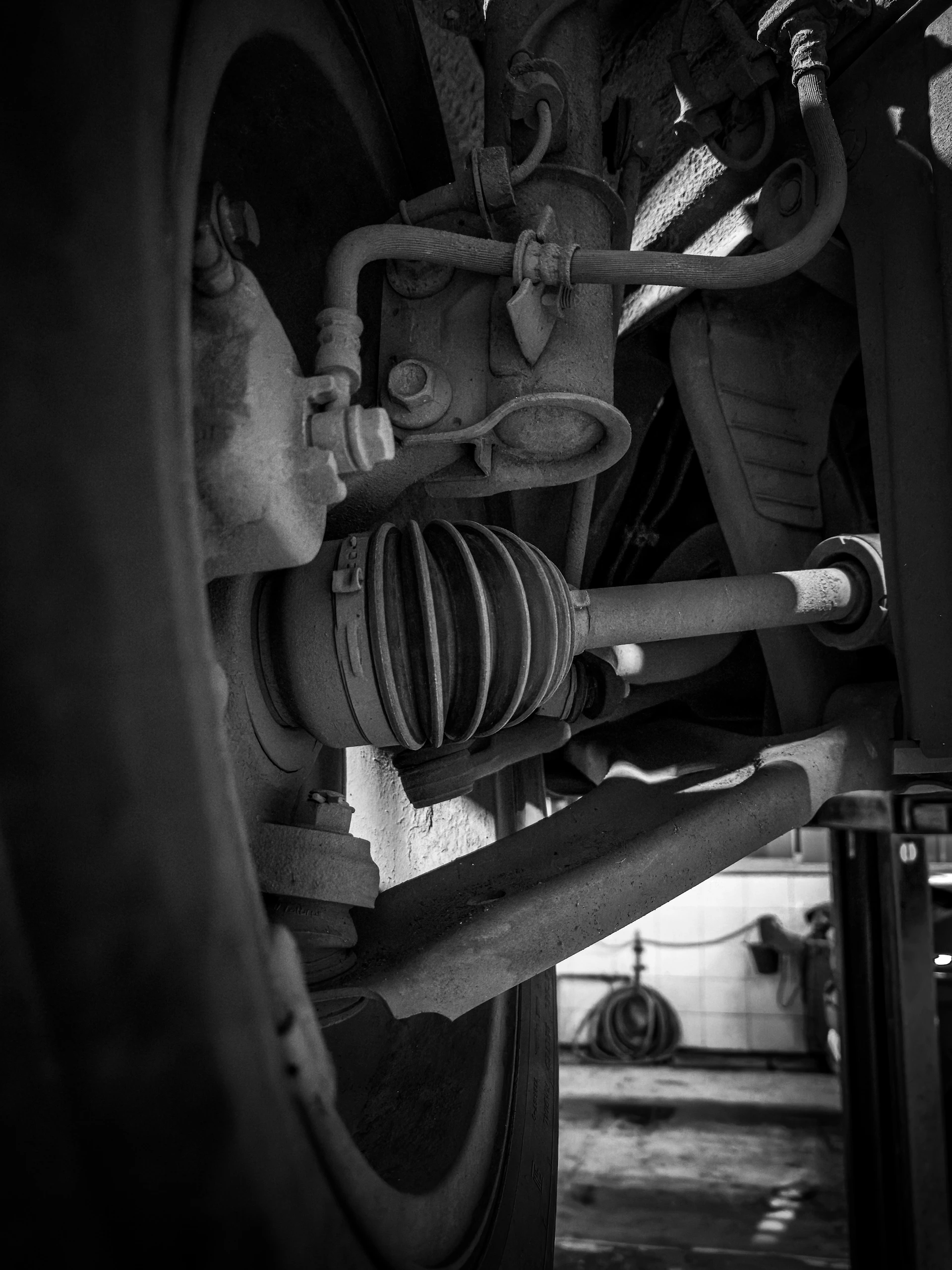 Close-up of a car's suspension and drive shaft