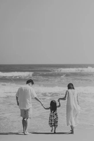 Family walking on the beach towards the ocean