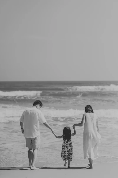 Family walking on the beach towards the ocean