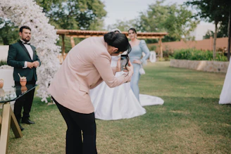 A photographer takes a picture of a bride and groom.