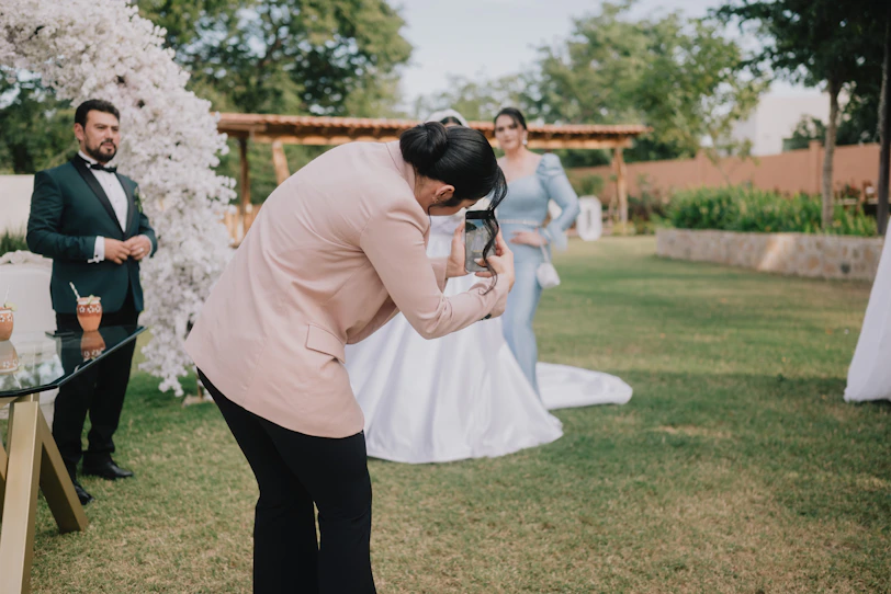 A photographer takes a picture of a bride and groom.