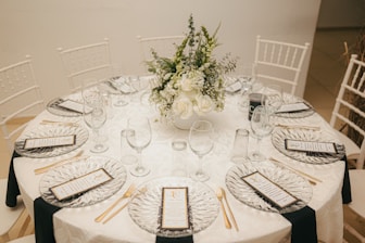 A beautifully set round table with floral centerpiece.