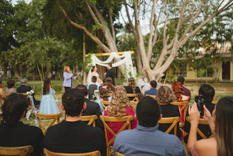 Wedding ceremony with guests seated outdoors