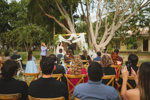 Wedding ceremony with guests seated outdoors