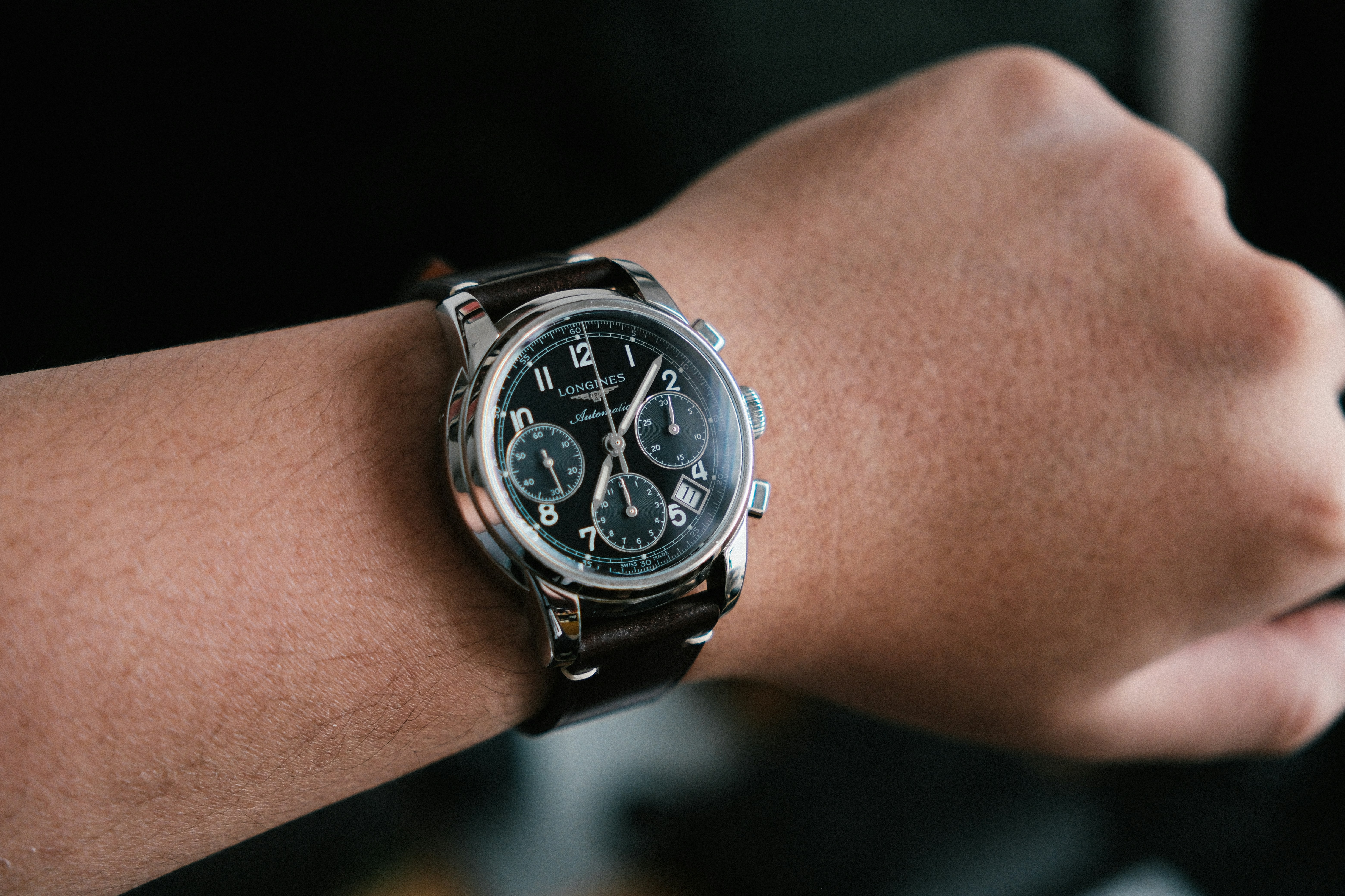 Close-up of a man's wrist wearing a chronograph watch
