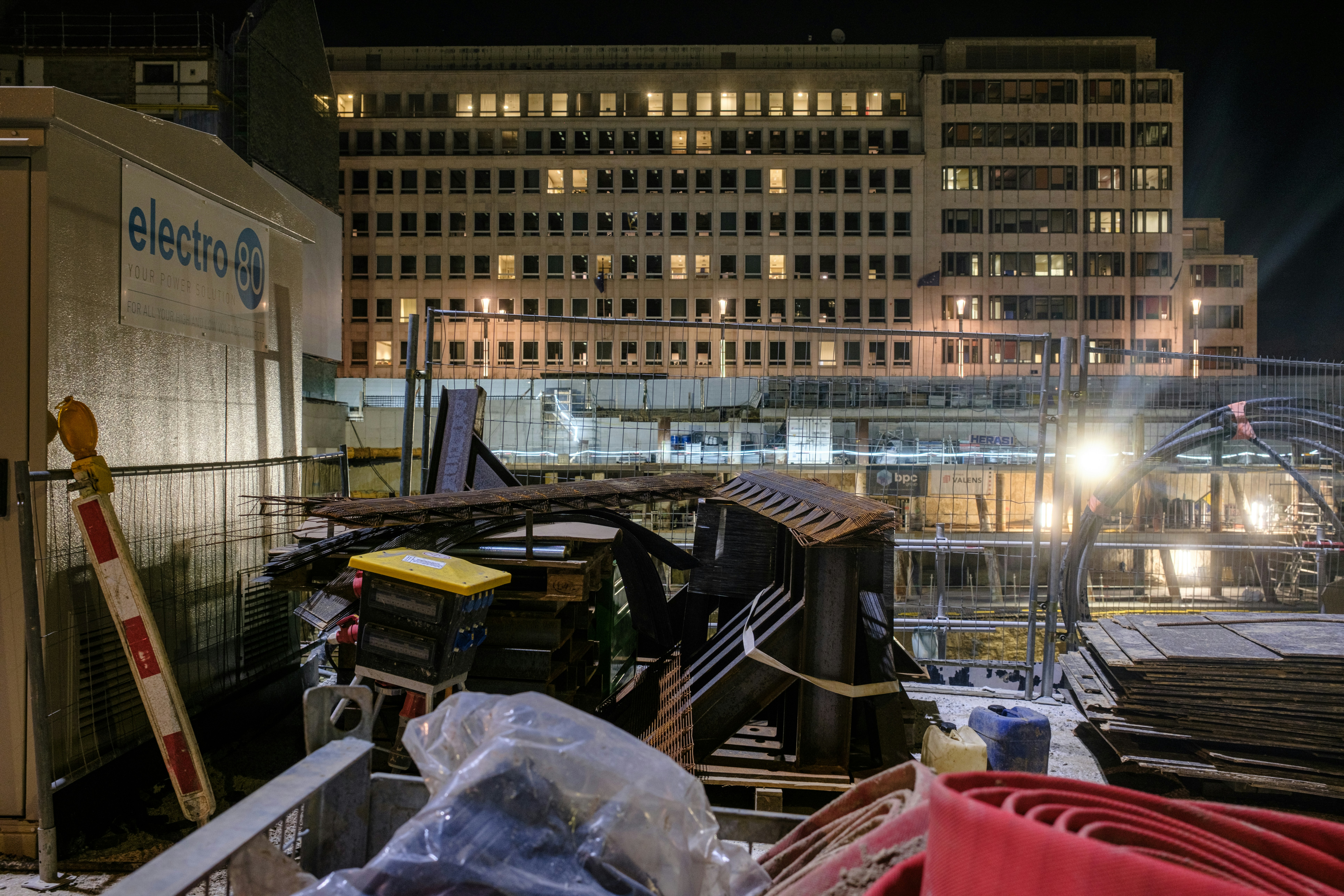 Construction site at night with building lights on