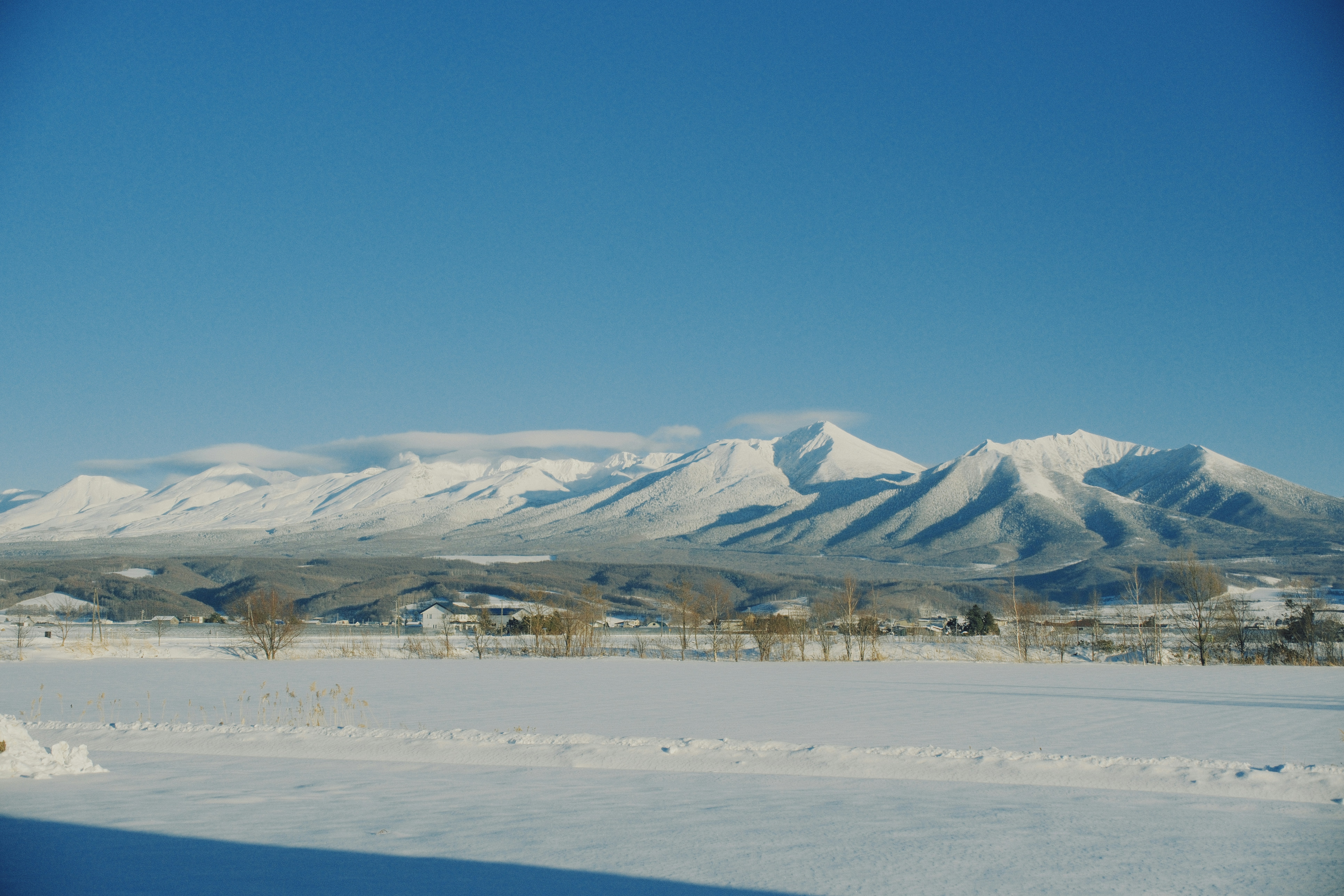 Snow-covered mountains under a clear blue sky