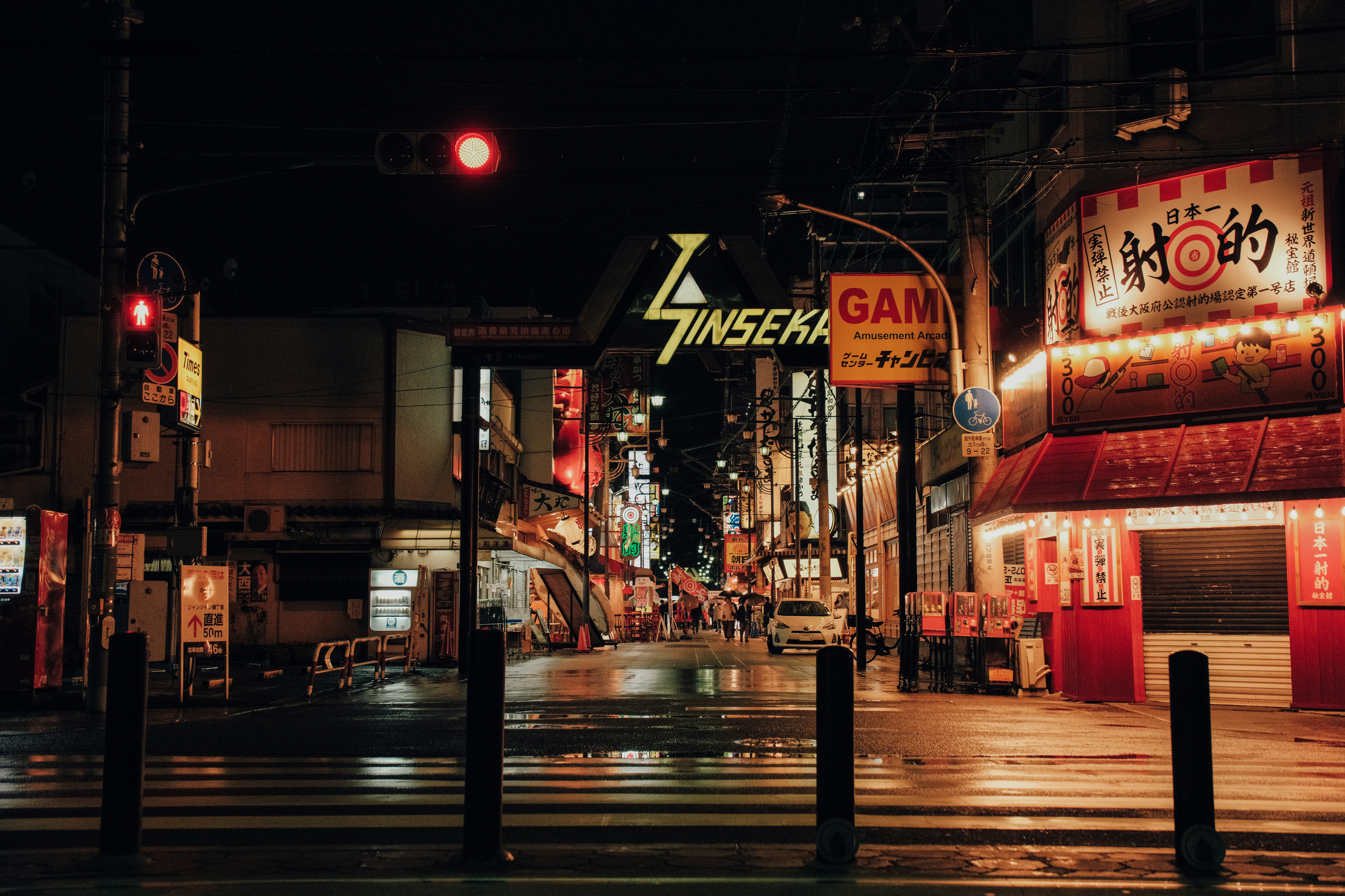 A neon-lit street in a japanese city at night.