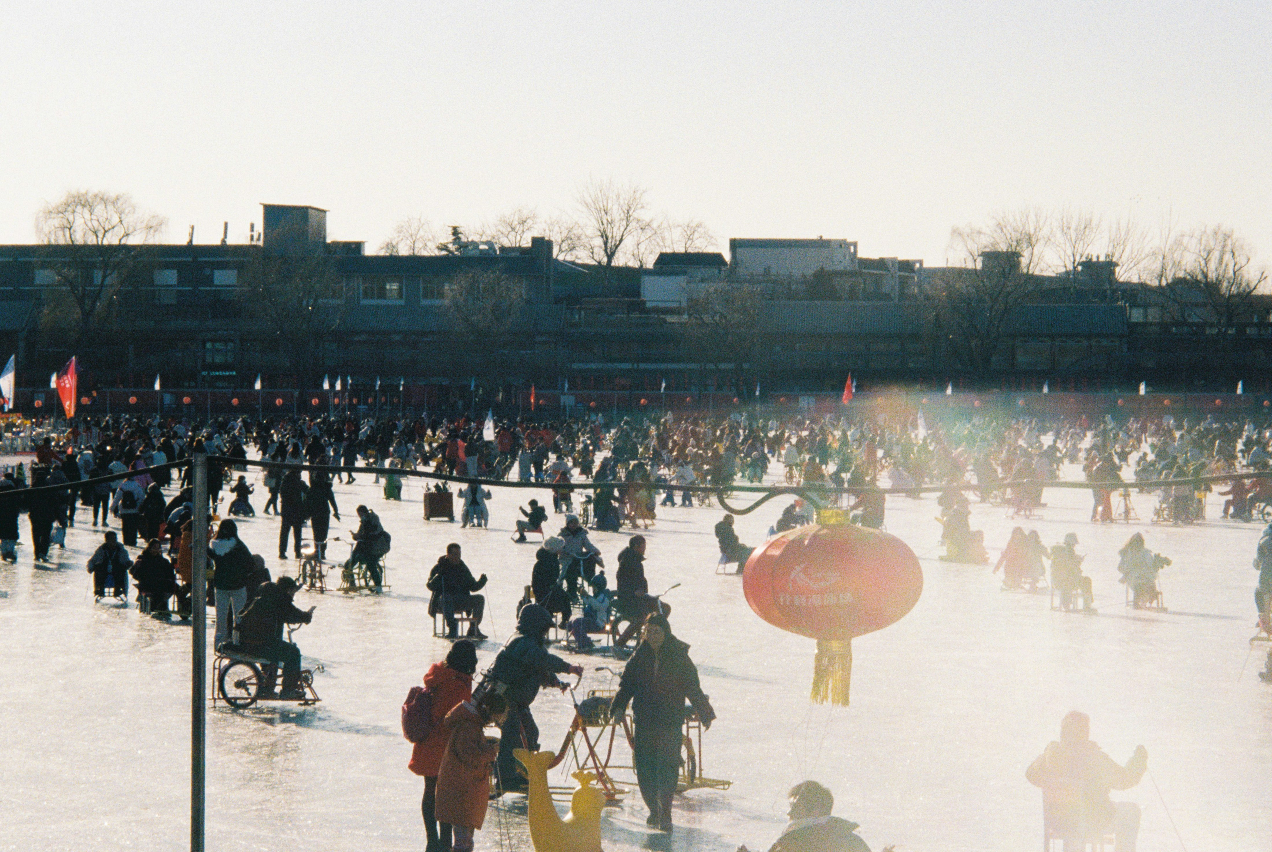 Crowd of people ice skating on a frozen lake