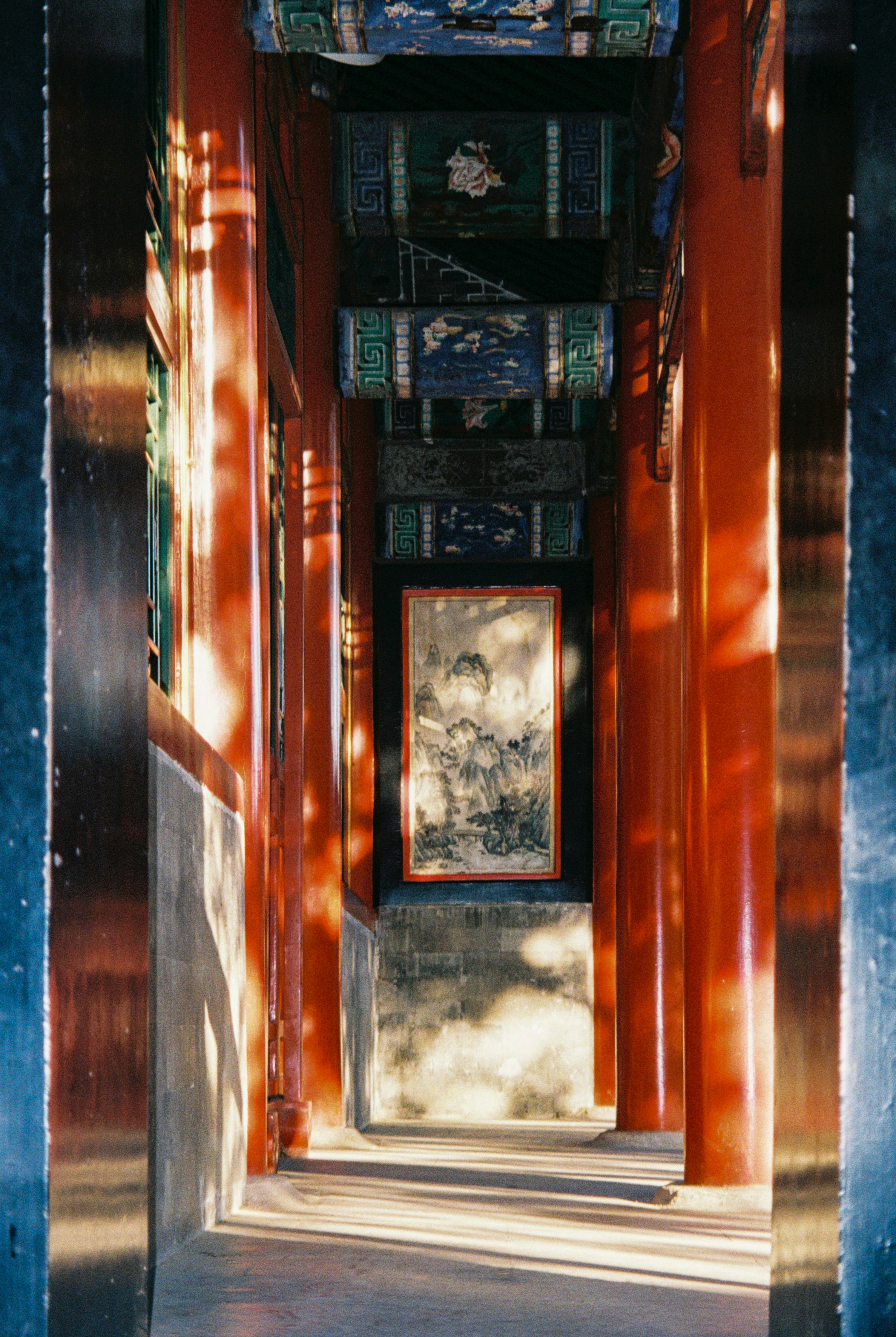 Red columns in a traditional chinese courtyard with painting.