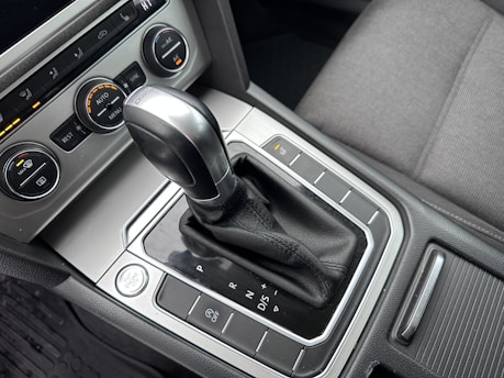 Close-up of an automatic car gear shift and dashboard controls