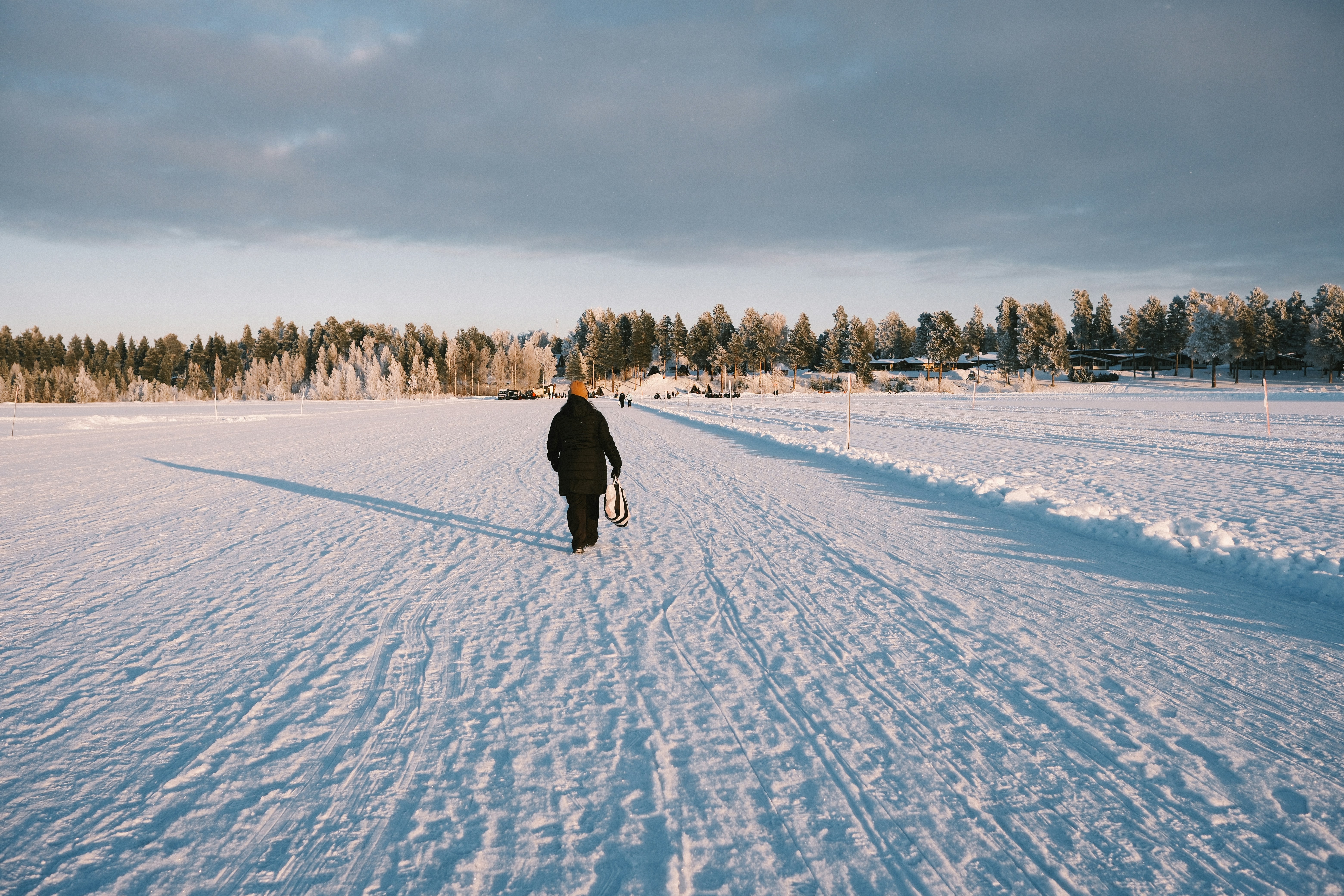 Person walking on a snow-covered path in winter
