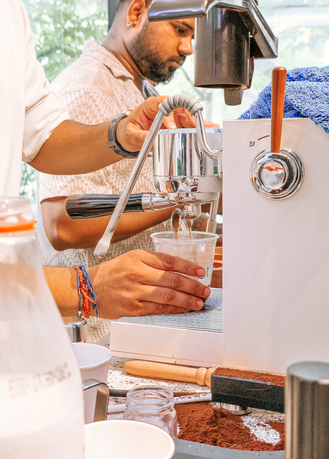 Espresso being extracted into a ceramic cup