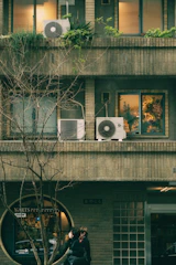 Couple embracing outside a circular window storefront.