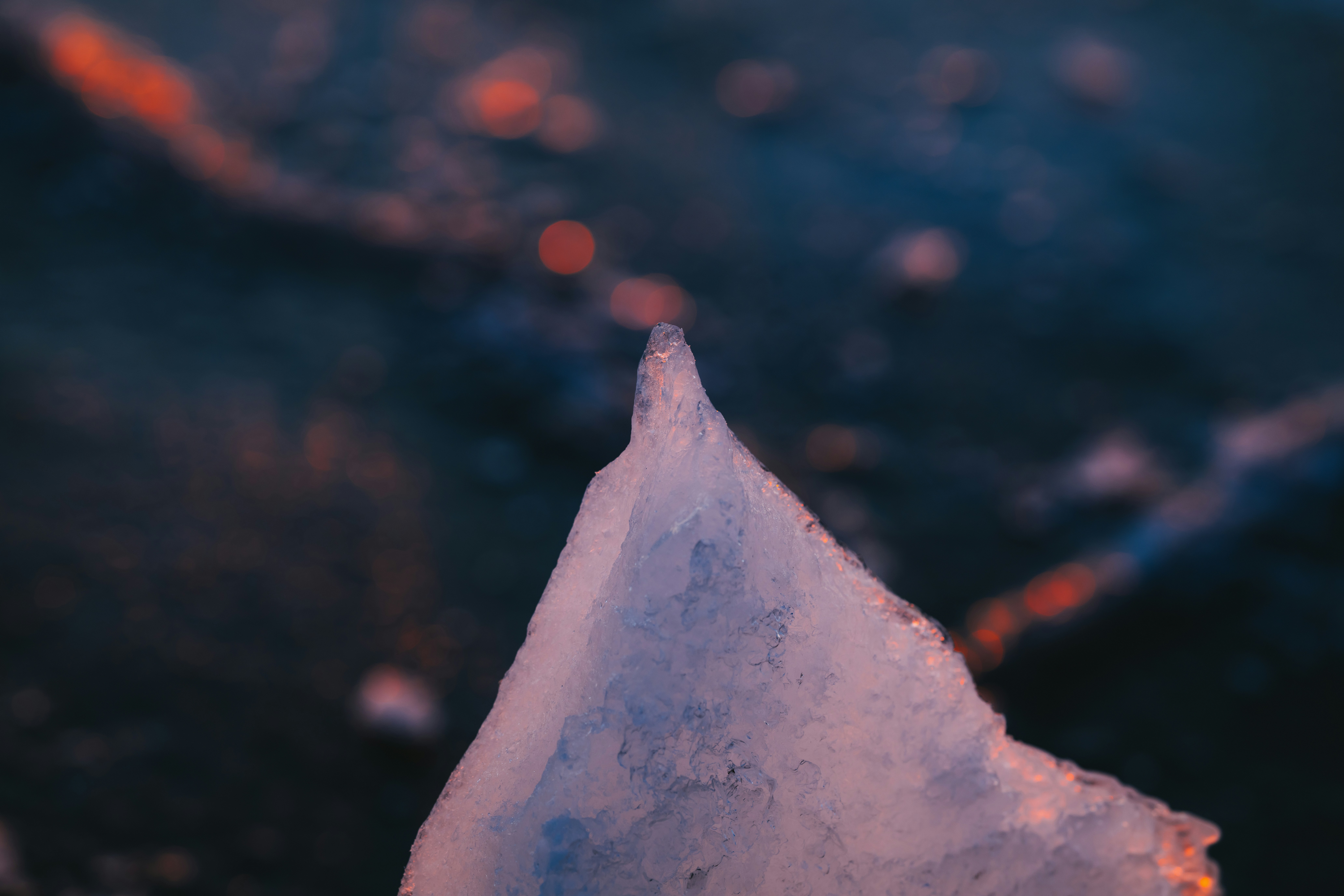 Close-up of a sharp ice shard against a blurred background