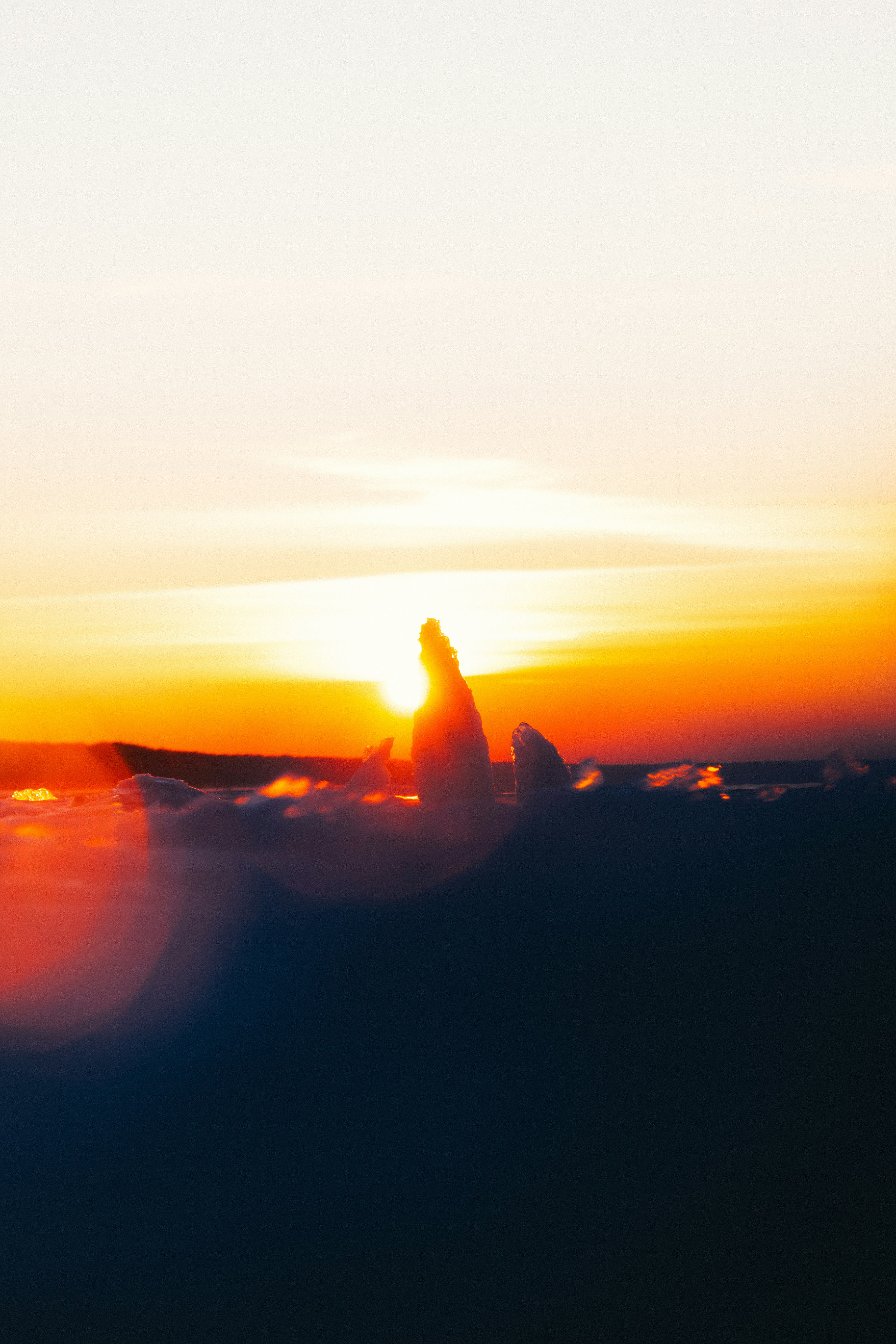 Sunset over clouds with lens flare