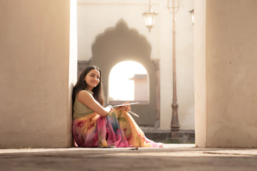 Young woman sitting and sketching outdoors