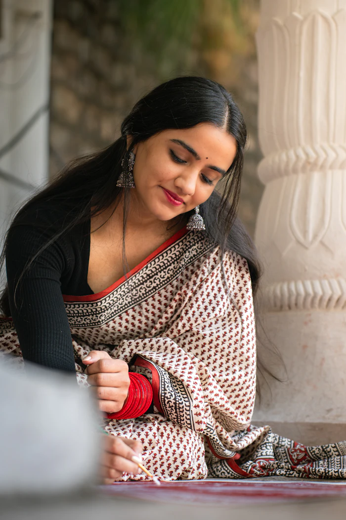 Illustrative stock portrait — Woman sketching outdoors in a sari
