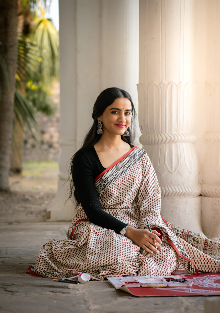 Illustrative stock portrait — Woman in a sari by a pillar