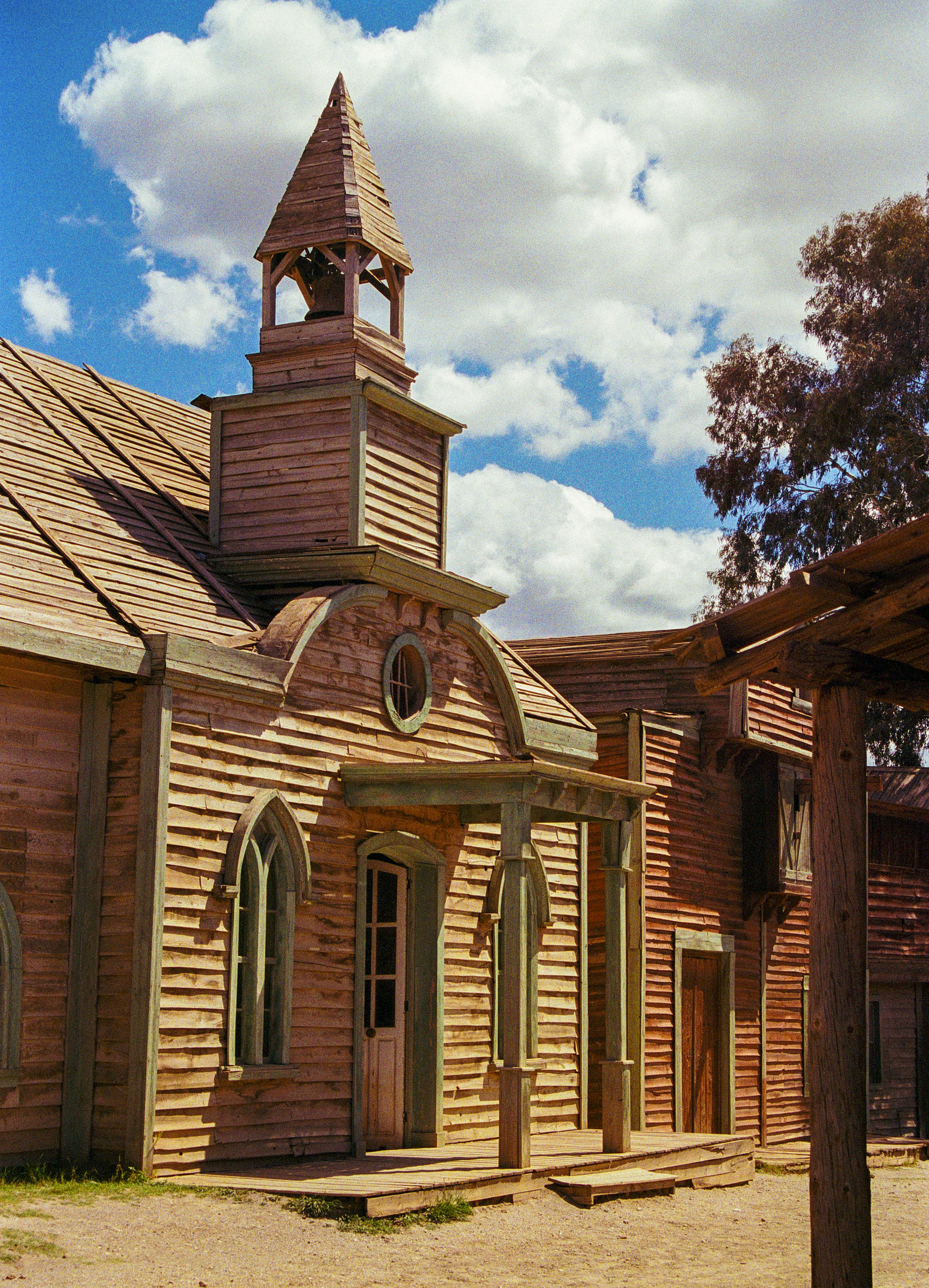 Wooden building with a steeple under a cloudy sky