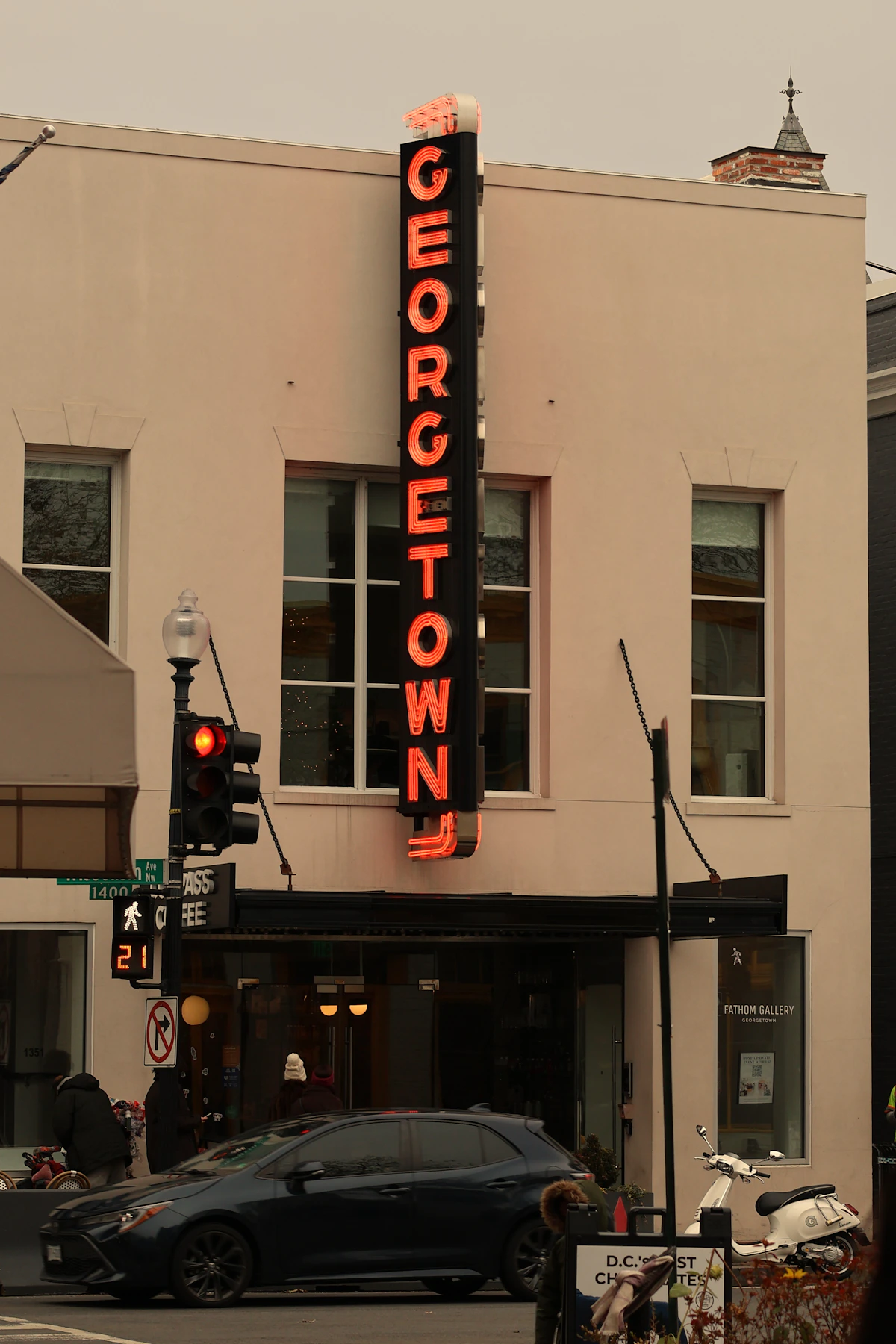 An early morning street beneath the Georgetown sign in Washington, D.C.