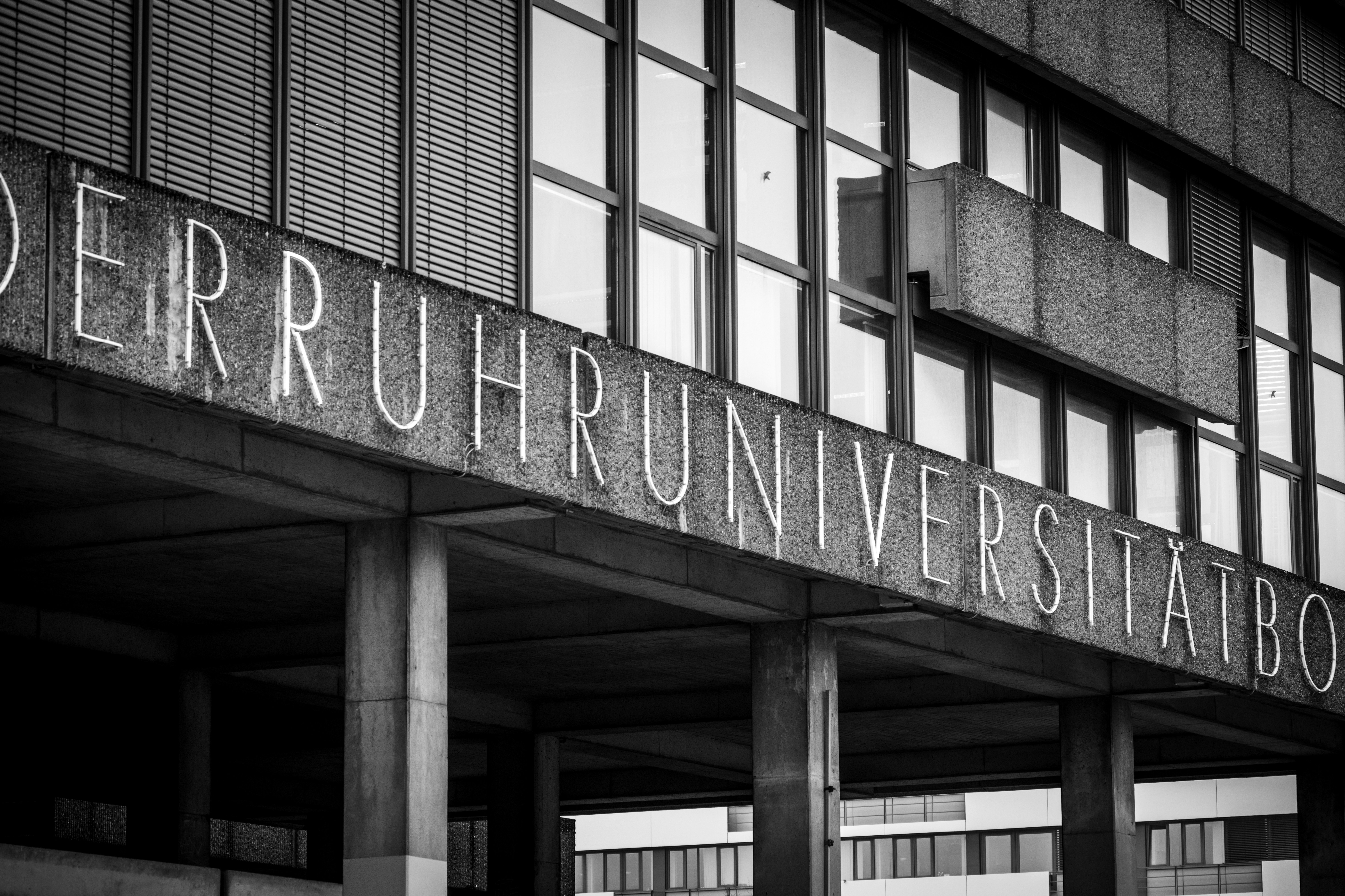 Concrete university building with large windows and modern windows