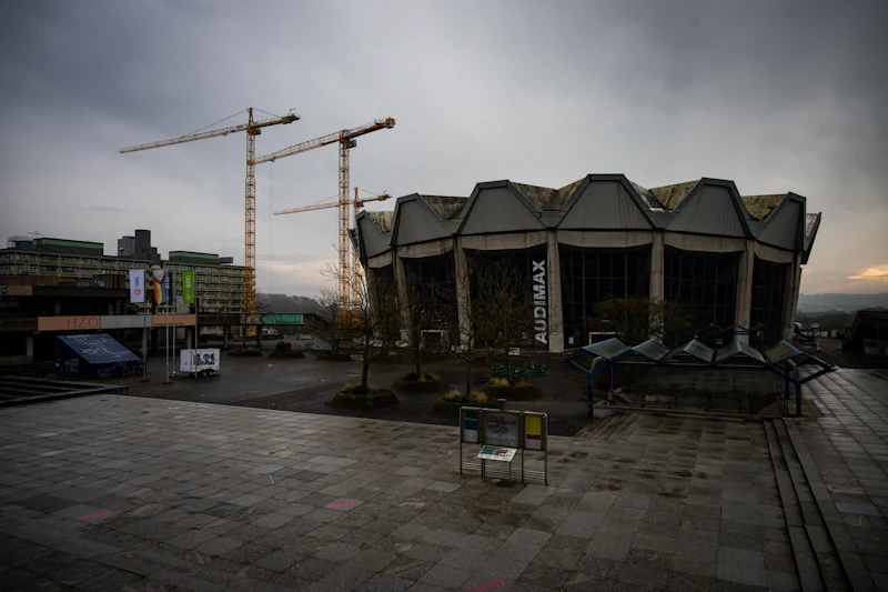 Construction site with cranes and a futuristic building