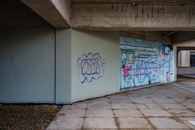 Graffiti art on a concrete wall under an overpass