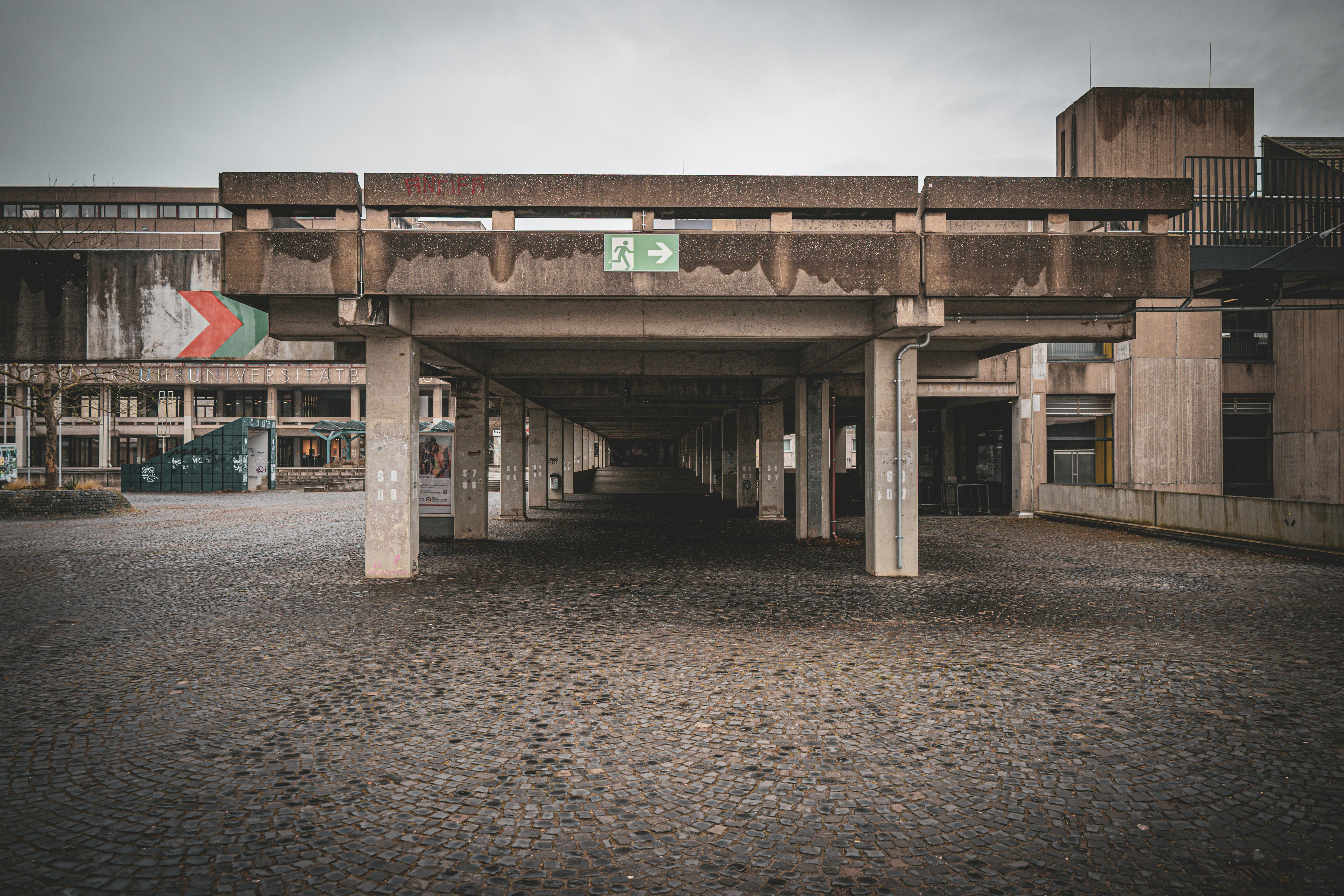 Concrete brutalist architecture with a covered walkway.