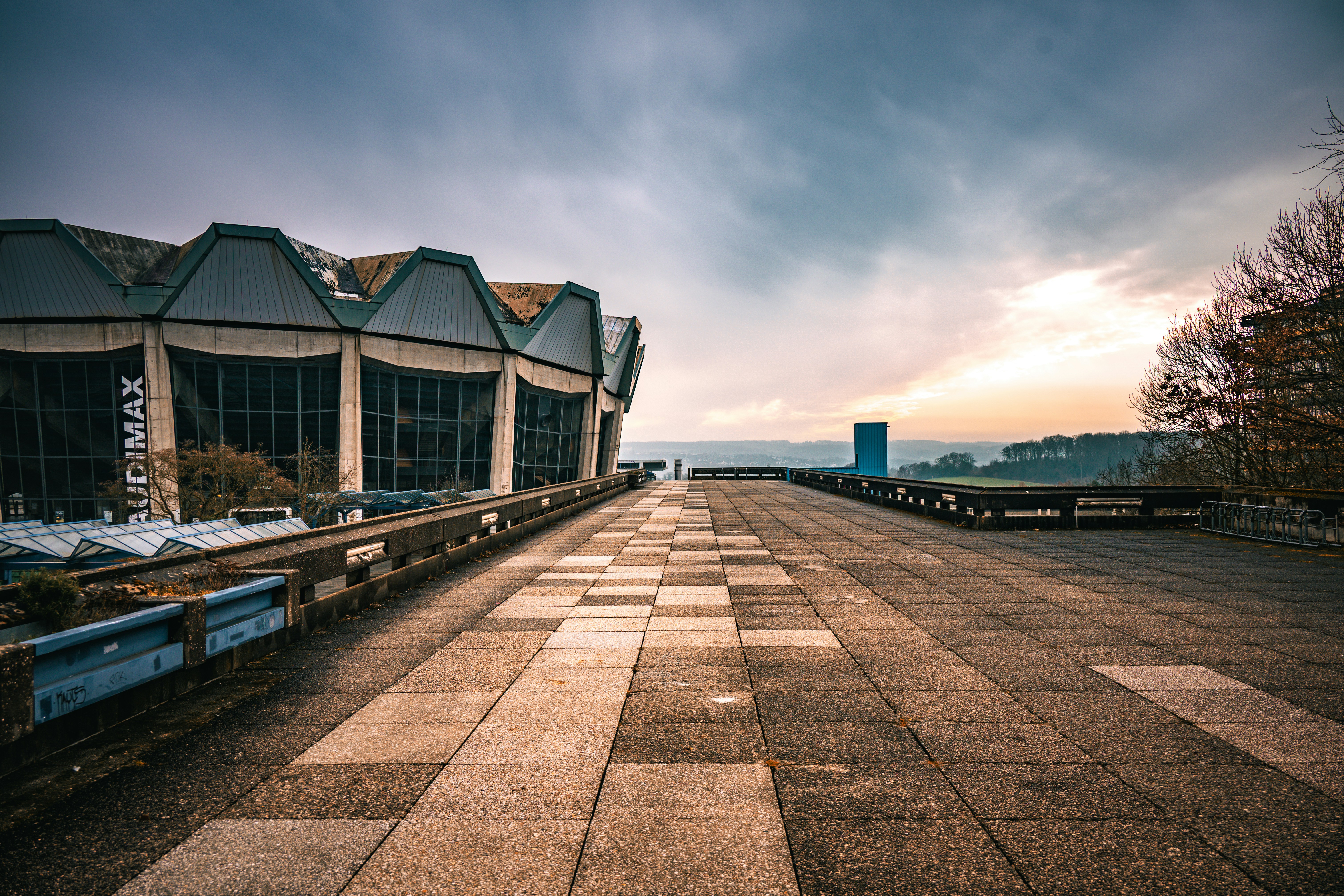 Abandoned industrial building with a tiled walkway.