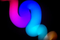 Abstract colorful light trails on black background