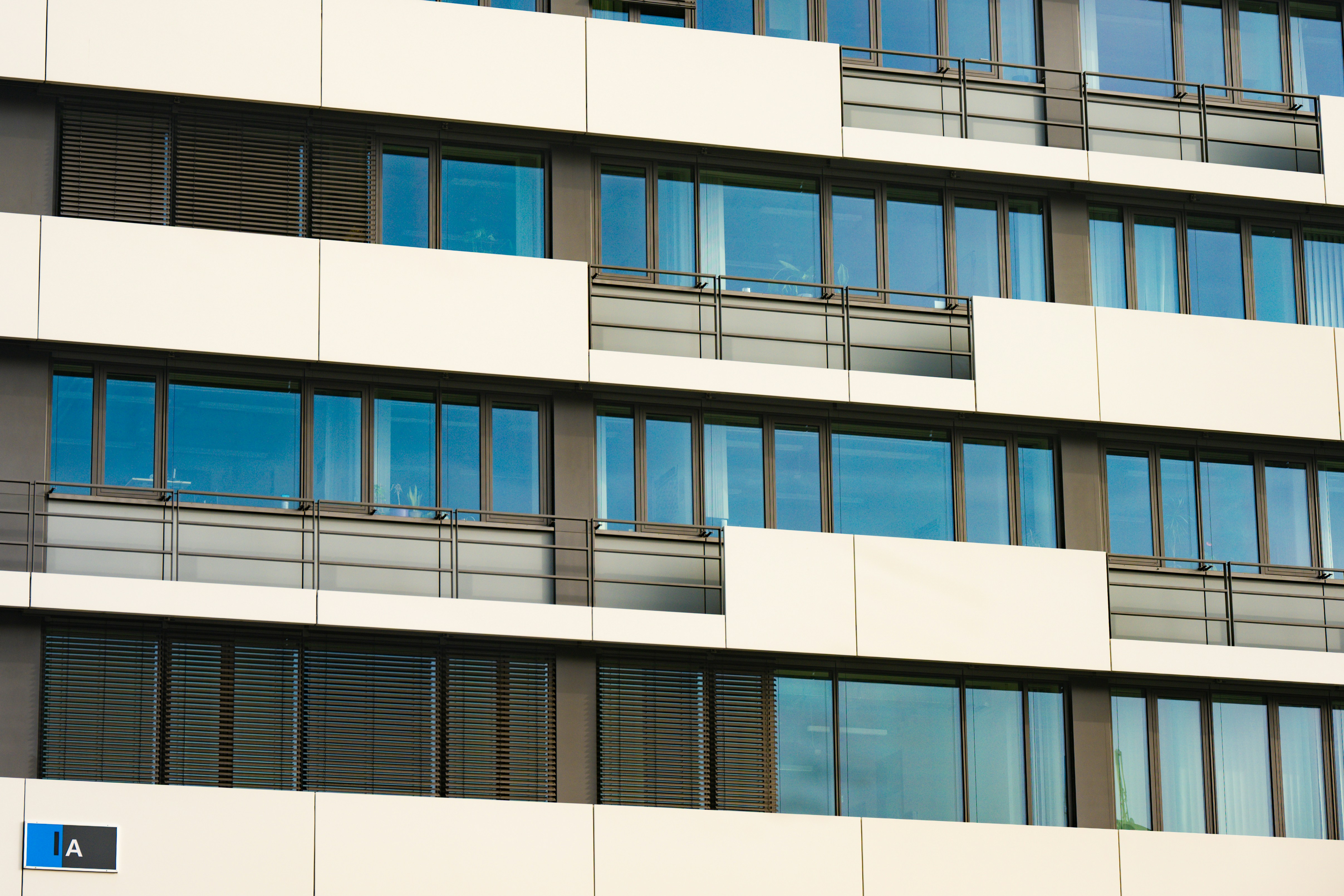 Modern building facade with reflective windows and white panels