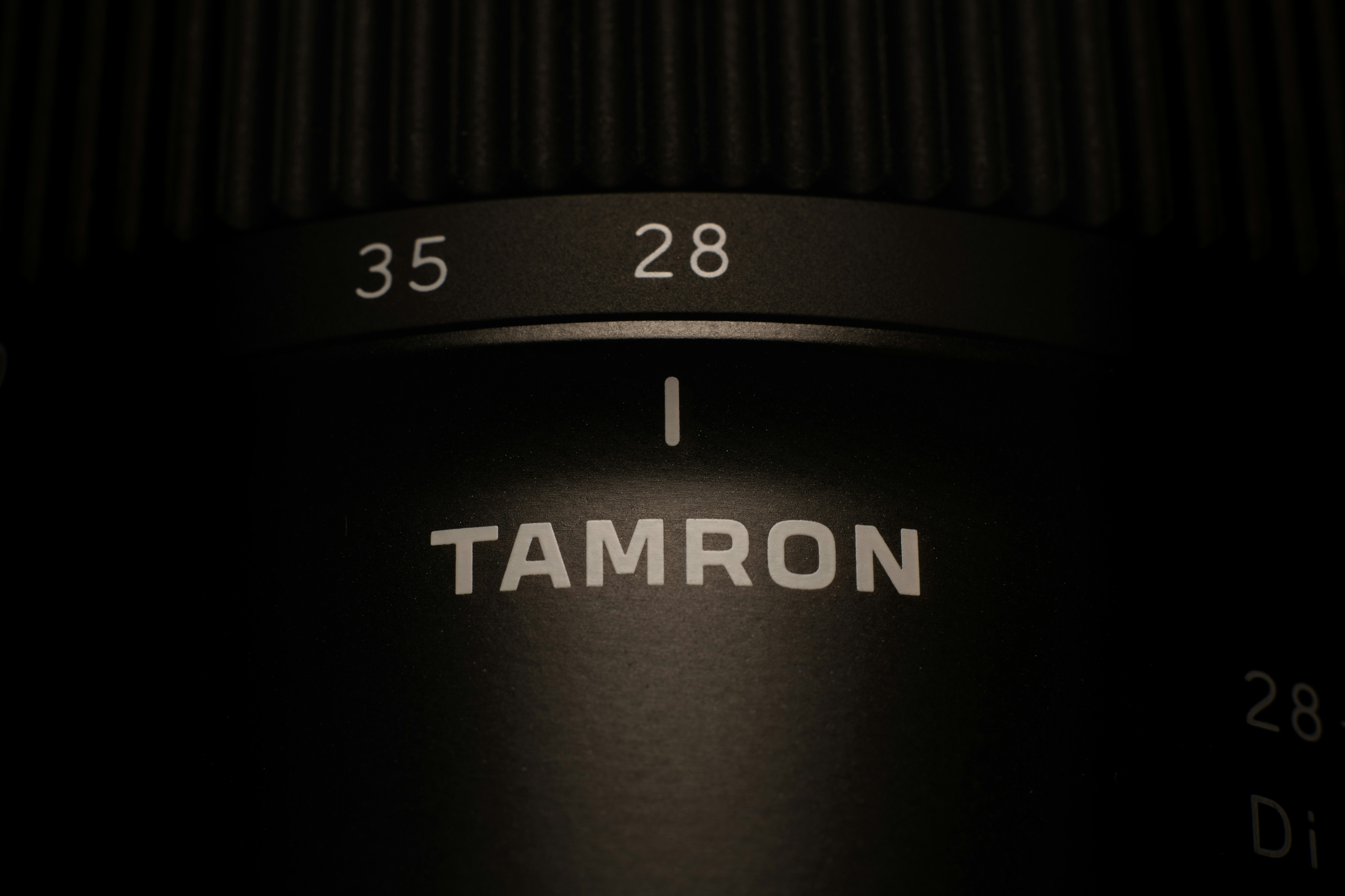 Close-up of a tamron camera lens with markings.