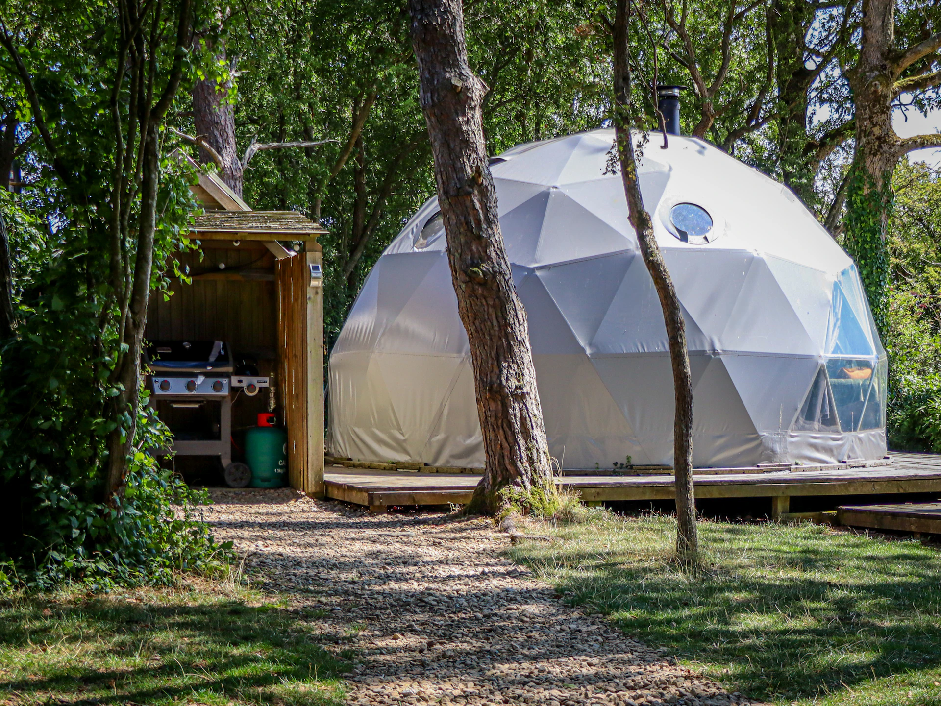 Geodesic dome glamping structure with outdoor kitchen