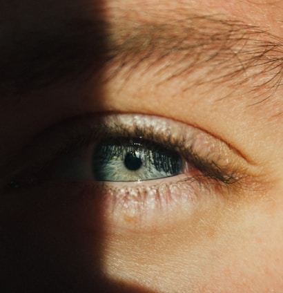 Close-up of a blue human eye with dramatic lighting