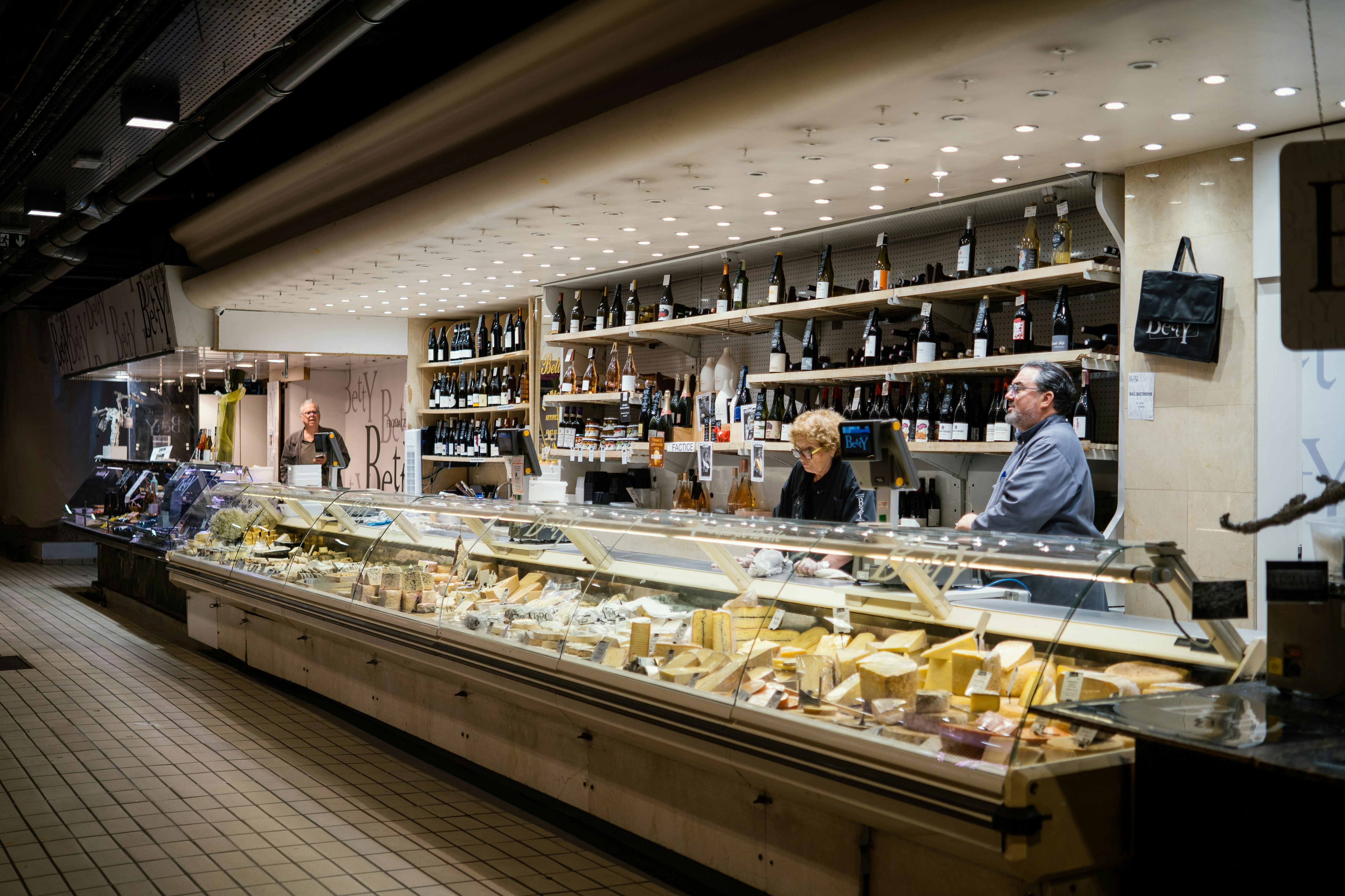Cheese and deli counter with staff behind it