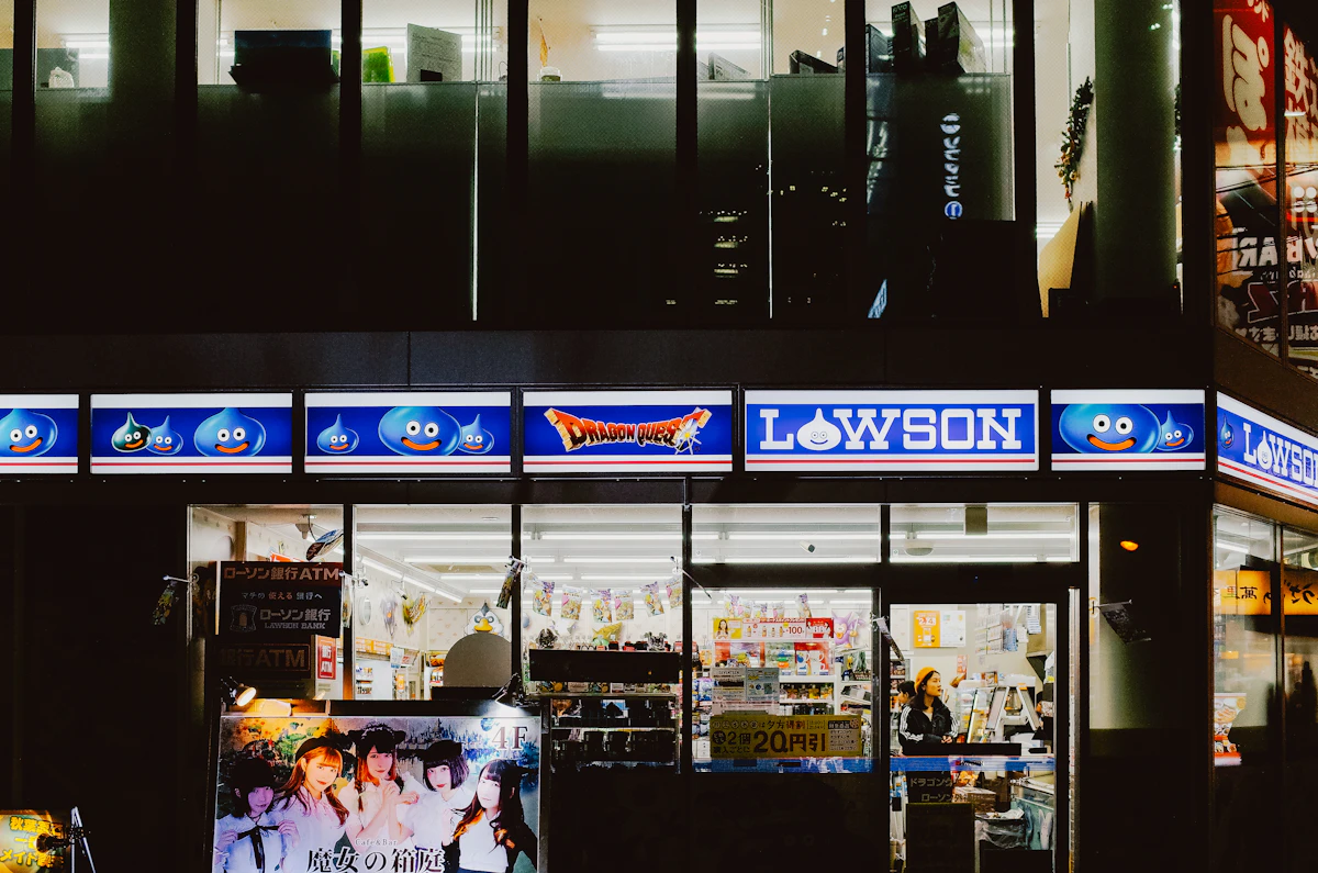 A brightly lit Lawson convenience store in Tokyo at night with neon illuminated signs