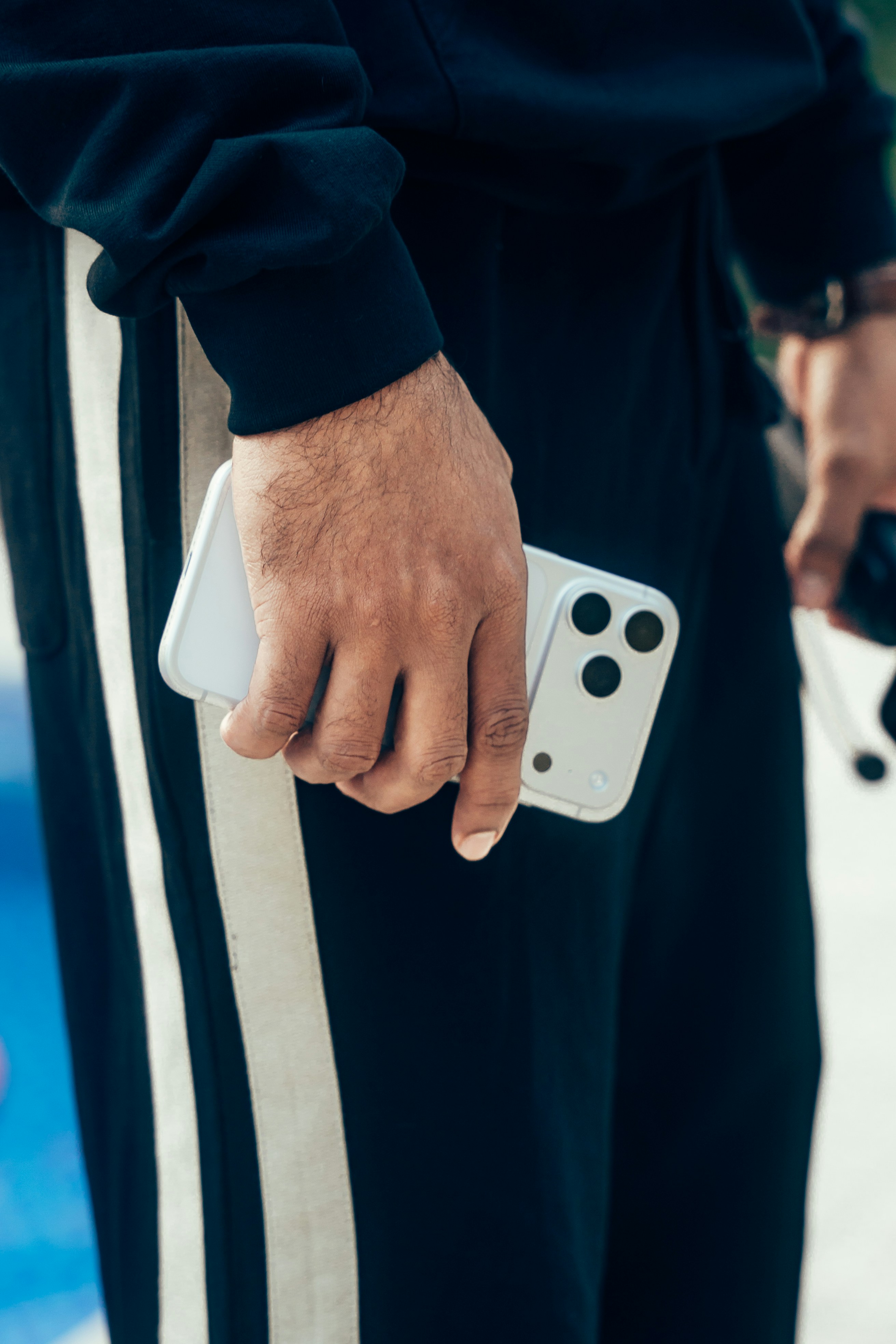 Person holding a modern smartphone with three cameras.