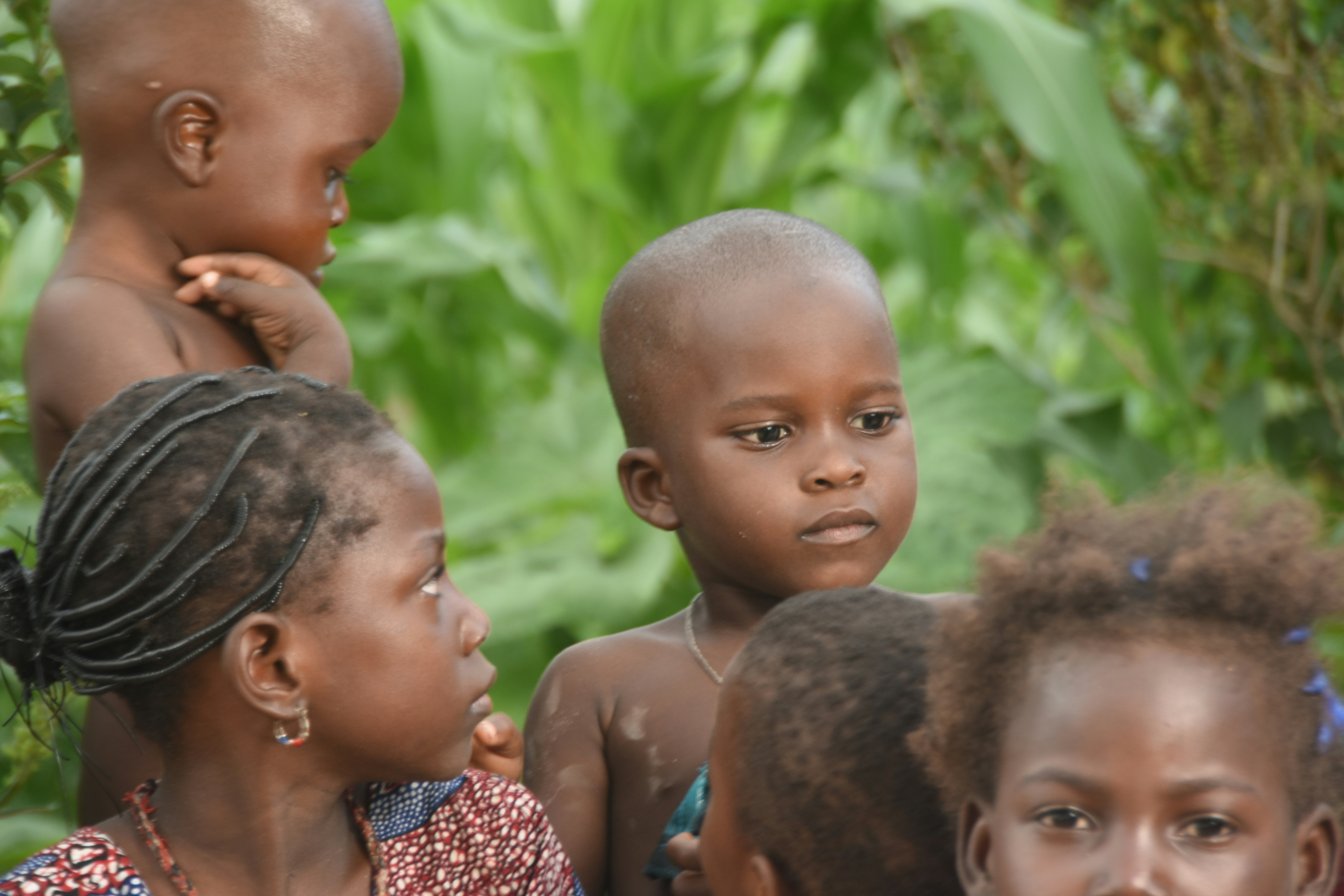 Several young children with dark skin and short hair.