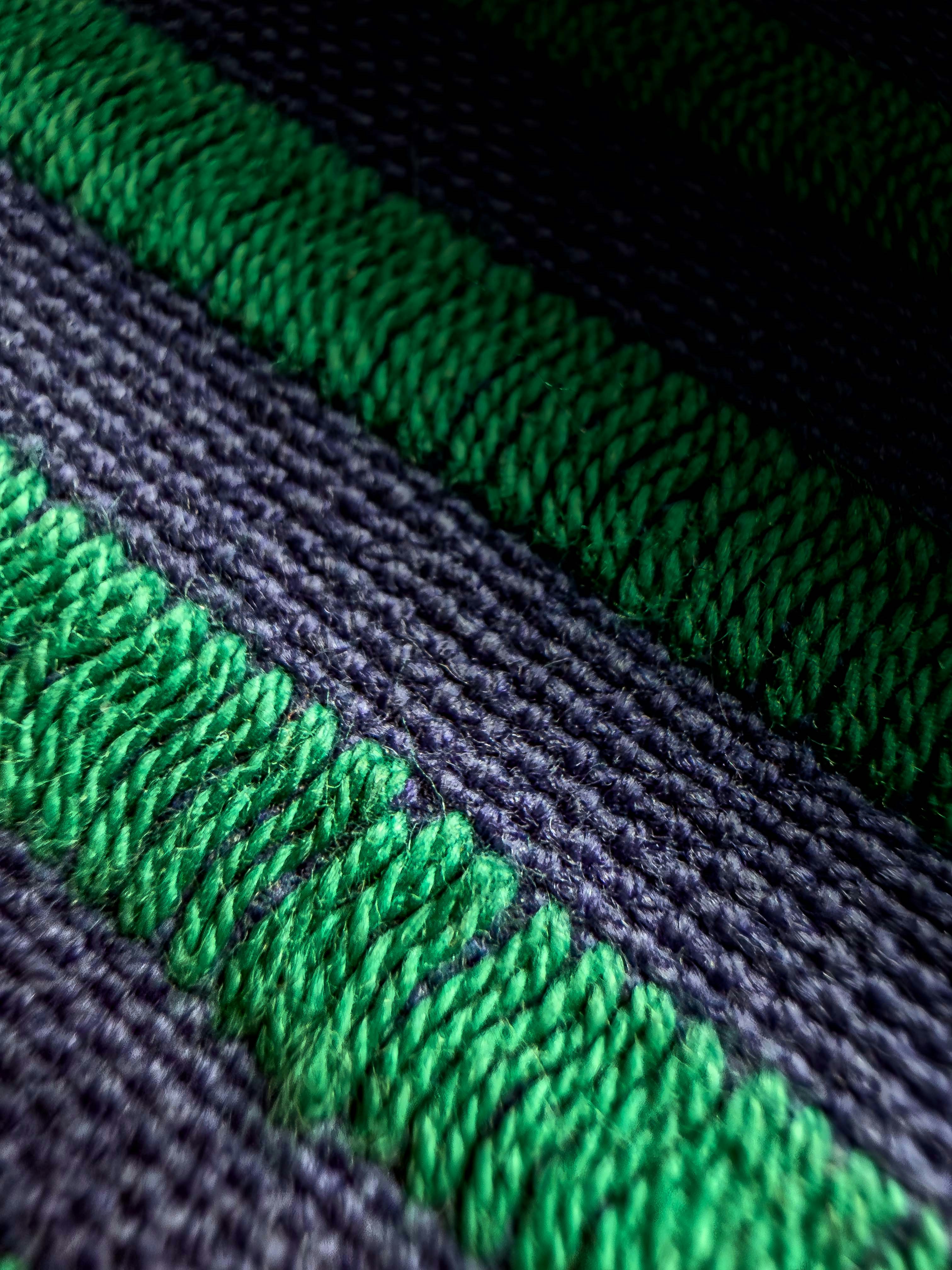 Close-up of navy blue and green striped knitted fabric
