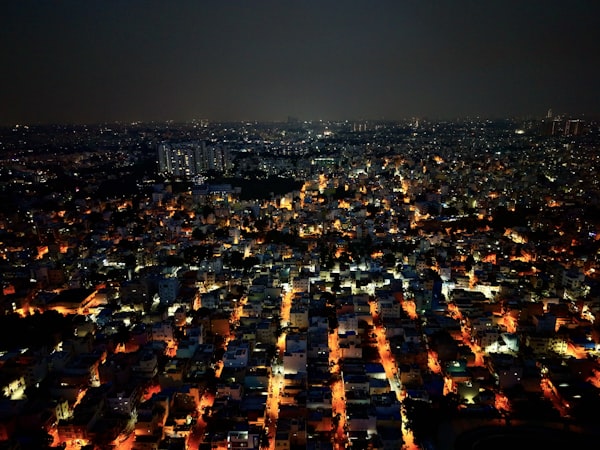 aerial view of a city at night, streets glowing orange