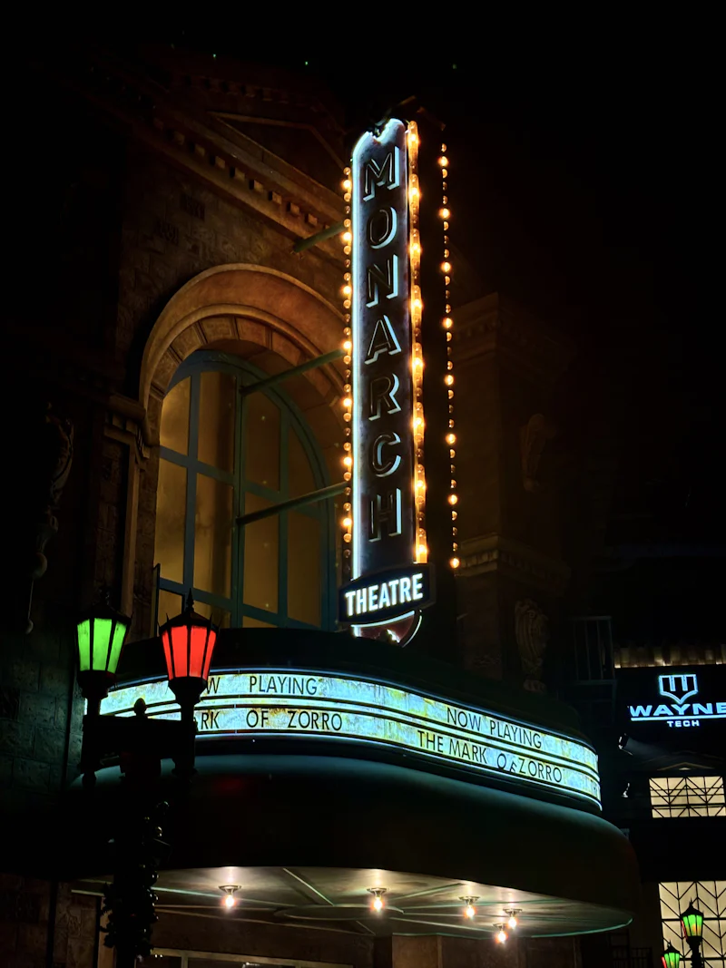 monarch theatre in warner bros world, abu dhabi, featuring a glowing marquee and vintage-inspired architecture that evokes classic cinema culture
