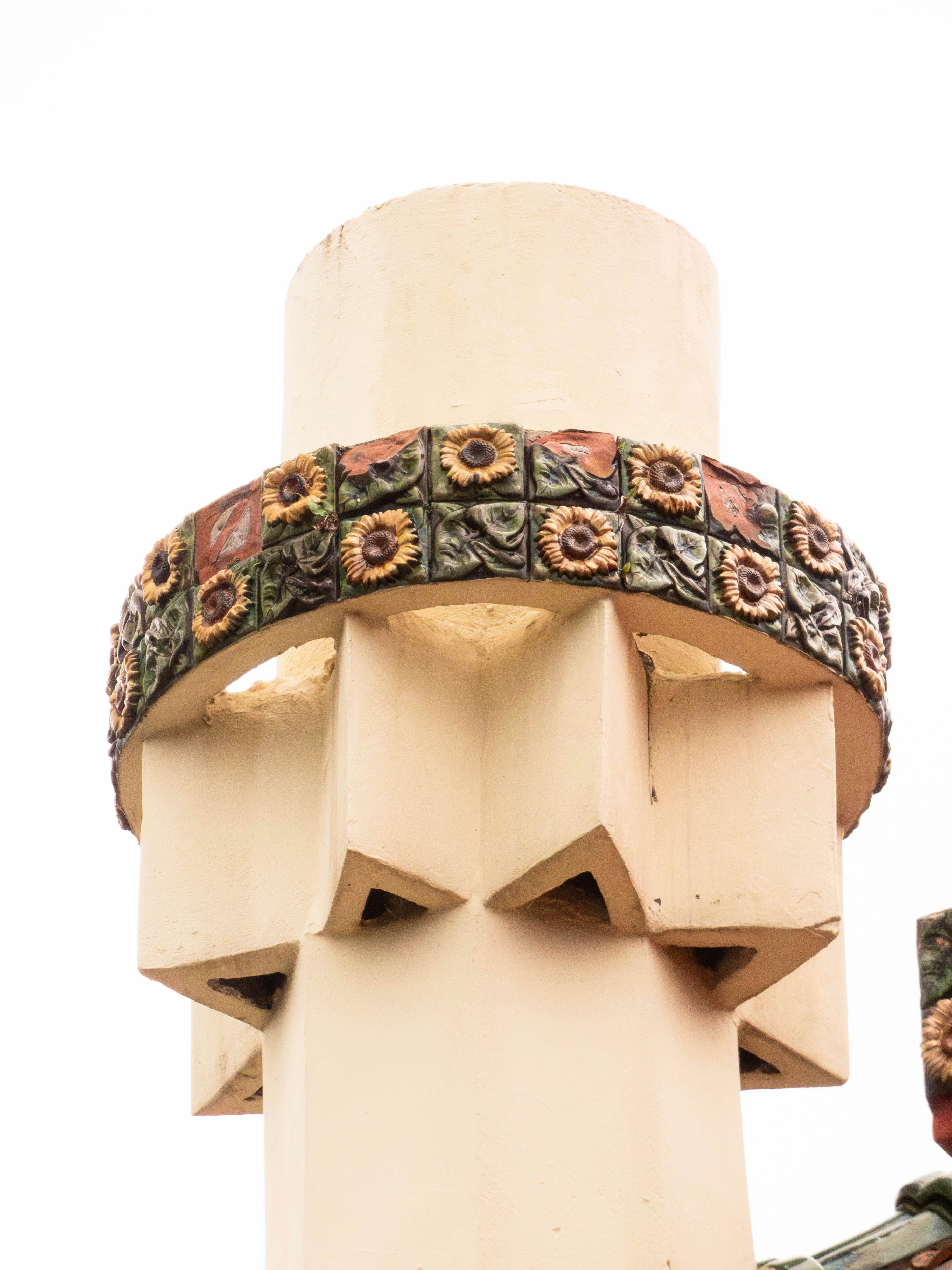 A decorative architectural detail with sunflower motifs.