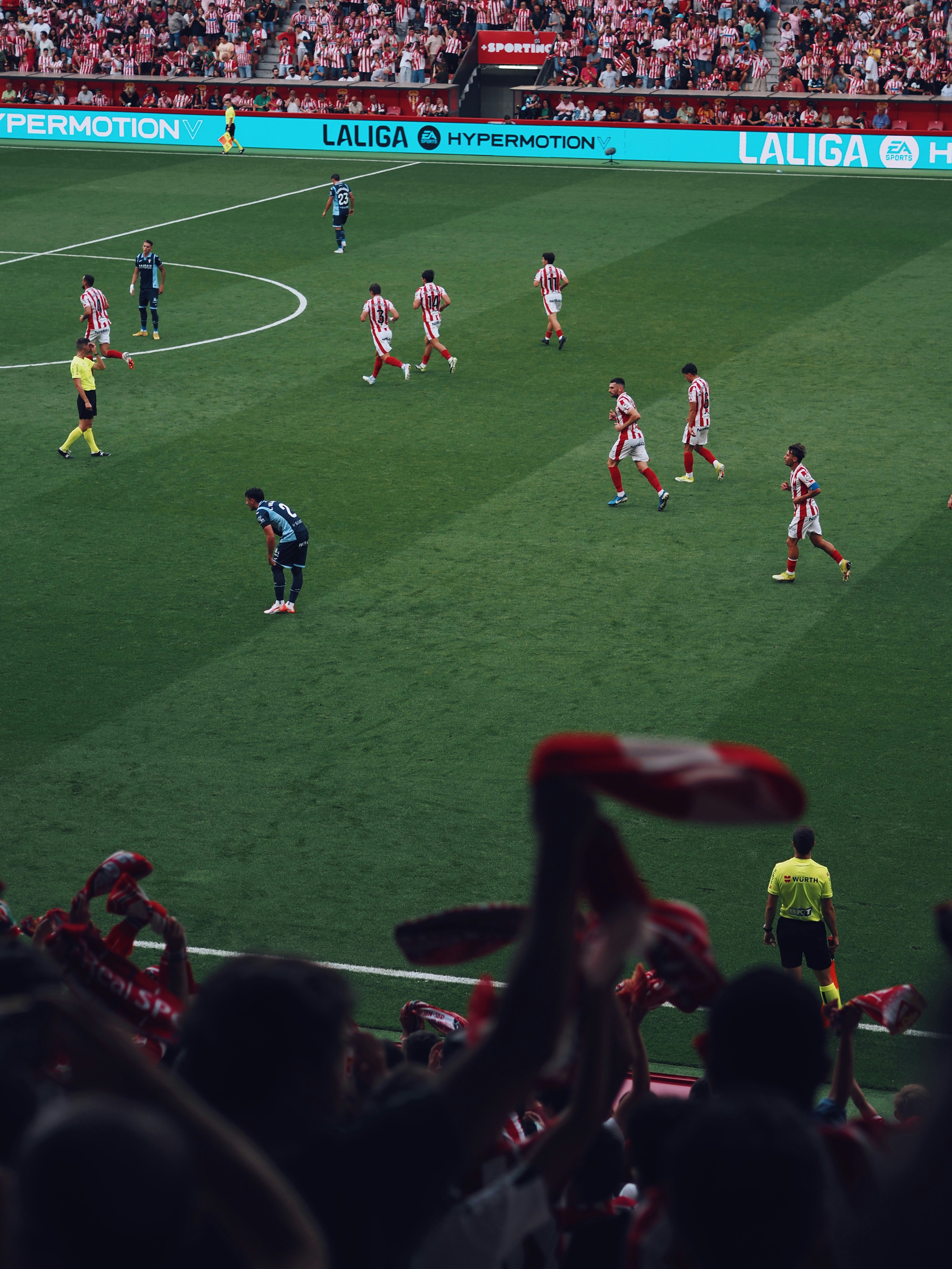 Soccer players on a green field during a match.
