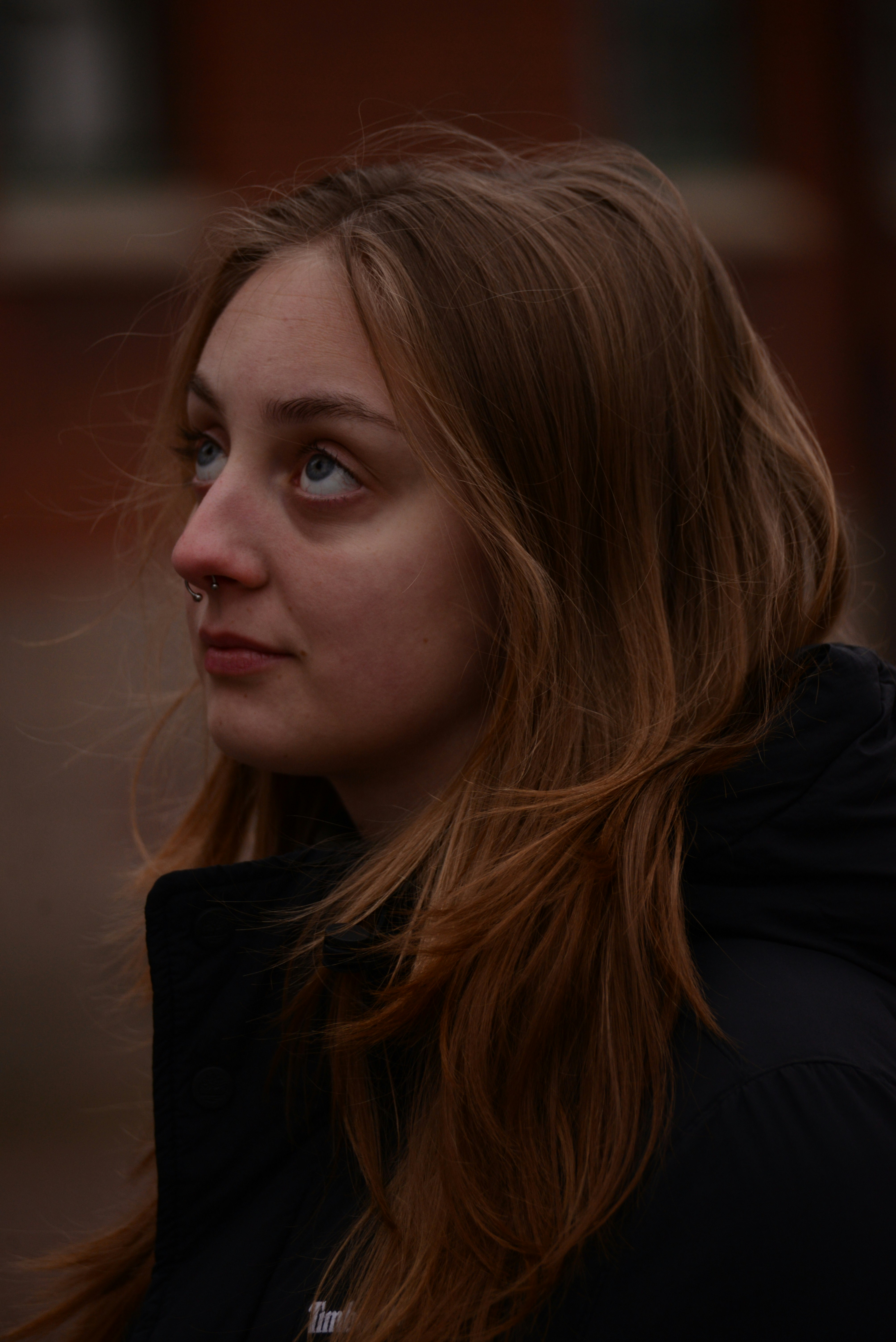 Young woman with blonde hair looking up