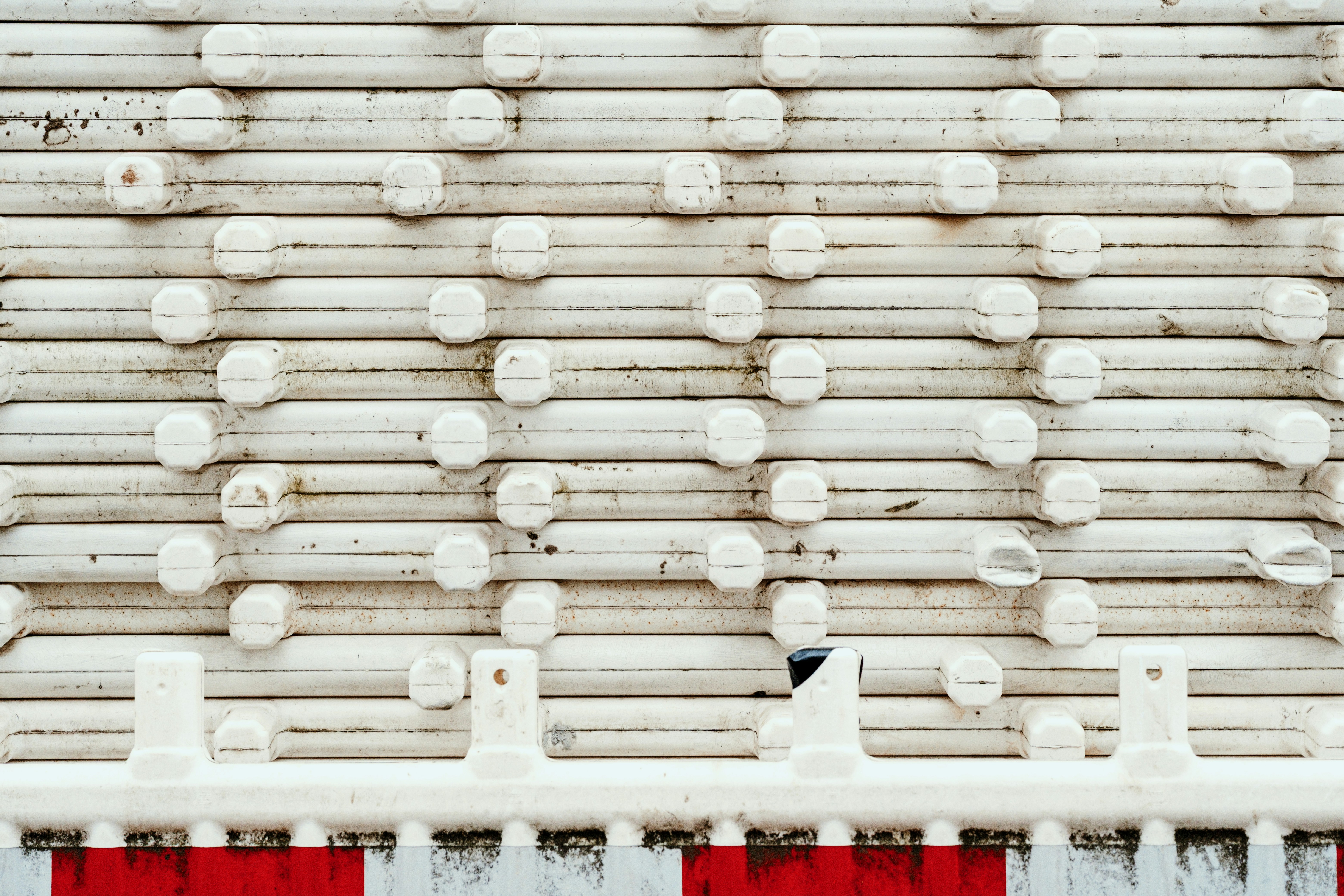 White plastic barrier with red and white stripes